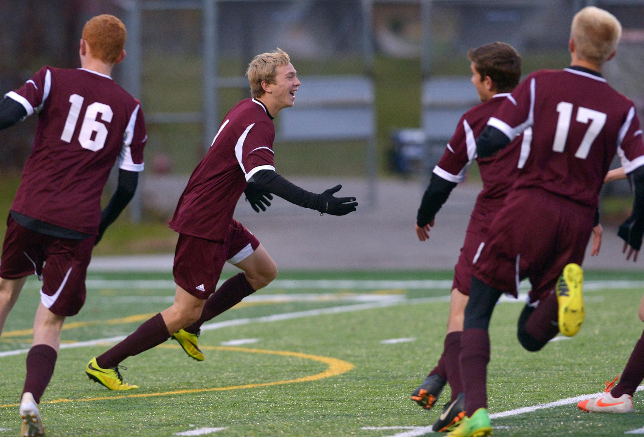 Anoka's Michael Talbot celebrates his free kick following the shootout of the Class 2A Boys' championship game Thursday, October 30 at Husky Stadium in St. Cloud. Anoka's 5-4 shot out victory over Wayzata names them 2014 Class 2A Boys' state champions. ] (SPECIAL TO THE STAR TRIBUNE/BRE McGEE) **Donnie Guimont (center, maroon, 13)