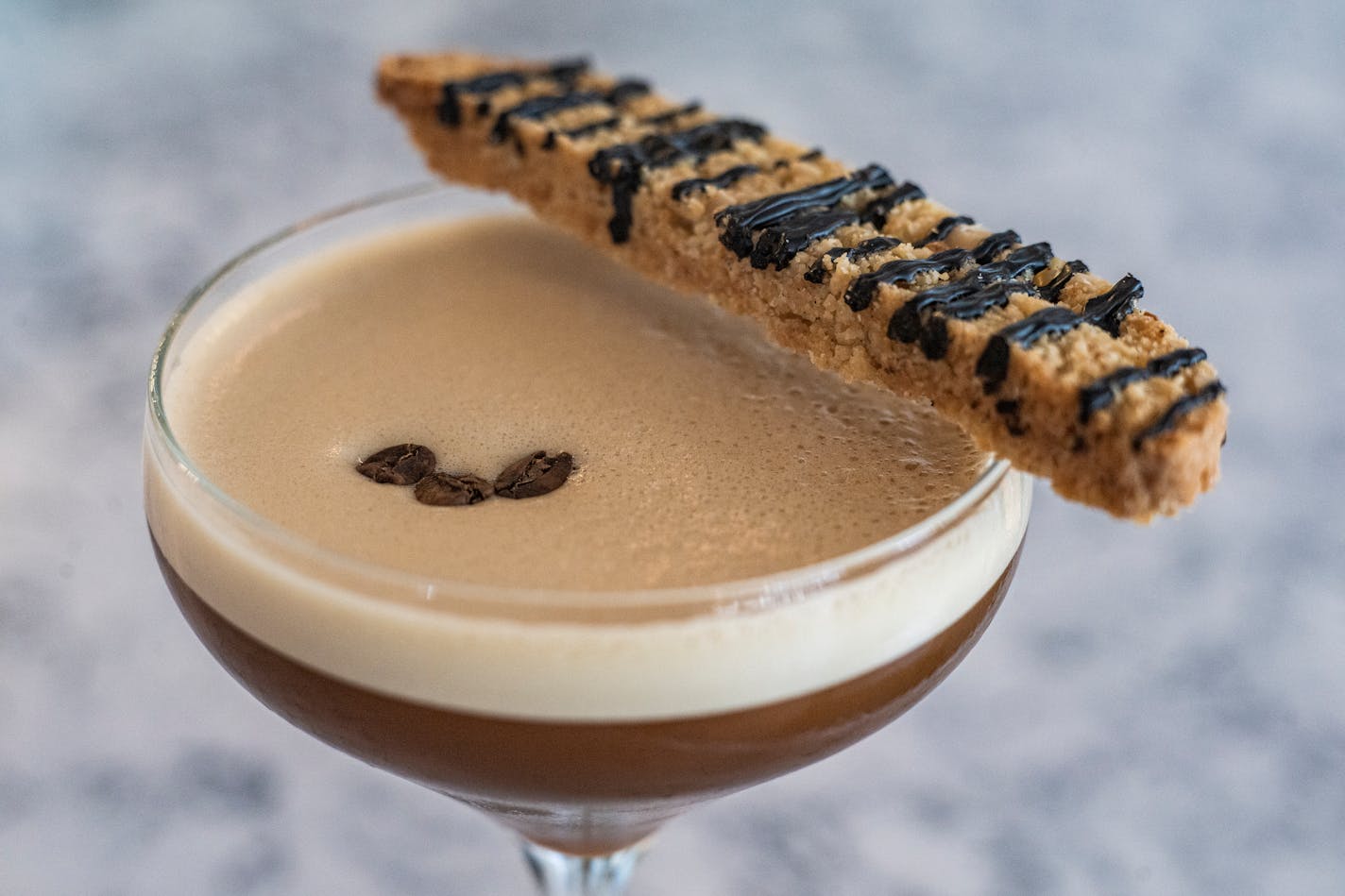 The Black Cat espresso martini at the Grocer’s Table in Wayzata comes with a housemade biscotti.