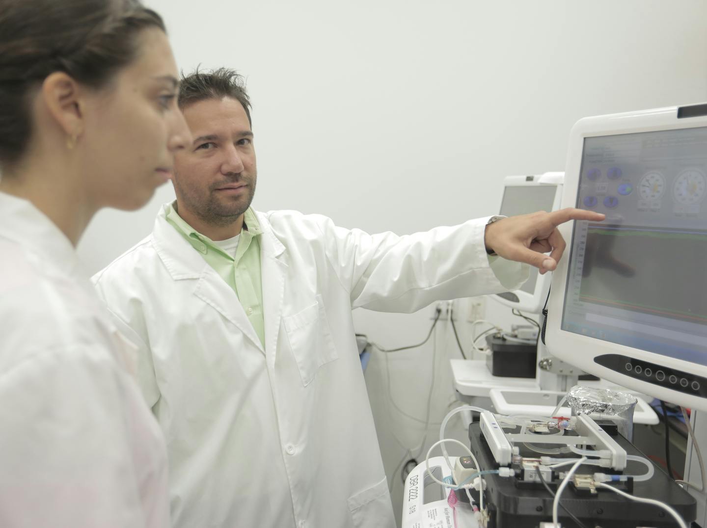 Two Minnetronix Medical employees examine a Neurapheresis Therapy system undergoing testing in the lab. Neurapheresis is a therapy that facilitates the removal of contaminants in the cerebral spinal fluid after a hemorrhagic stroke. (Provided by Minnetronix Medical.)