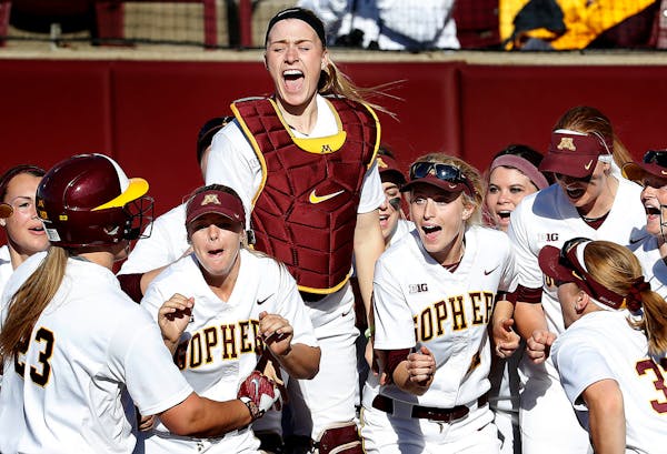 Gophers catcher Kendyl Lindaman (23) was greeted by teammates after hitting a three run home run in the second inning.