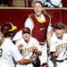 Gophers catcher Kendyl Lindaman (23) was greeted by teammates after hitting a three run home run in the second inning.