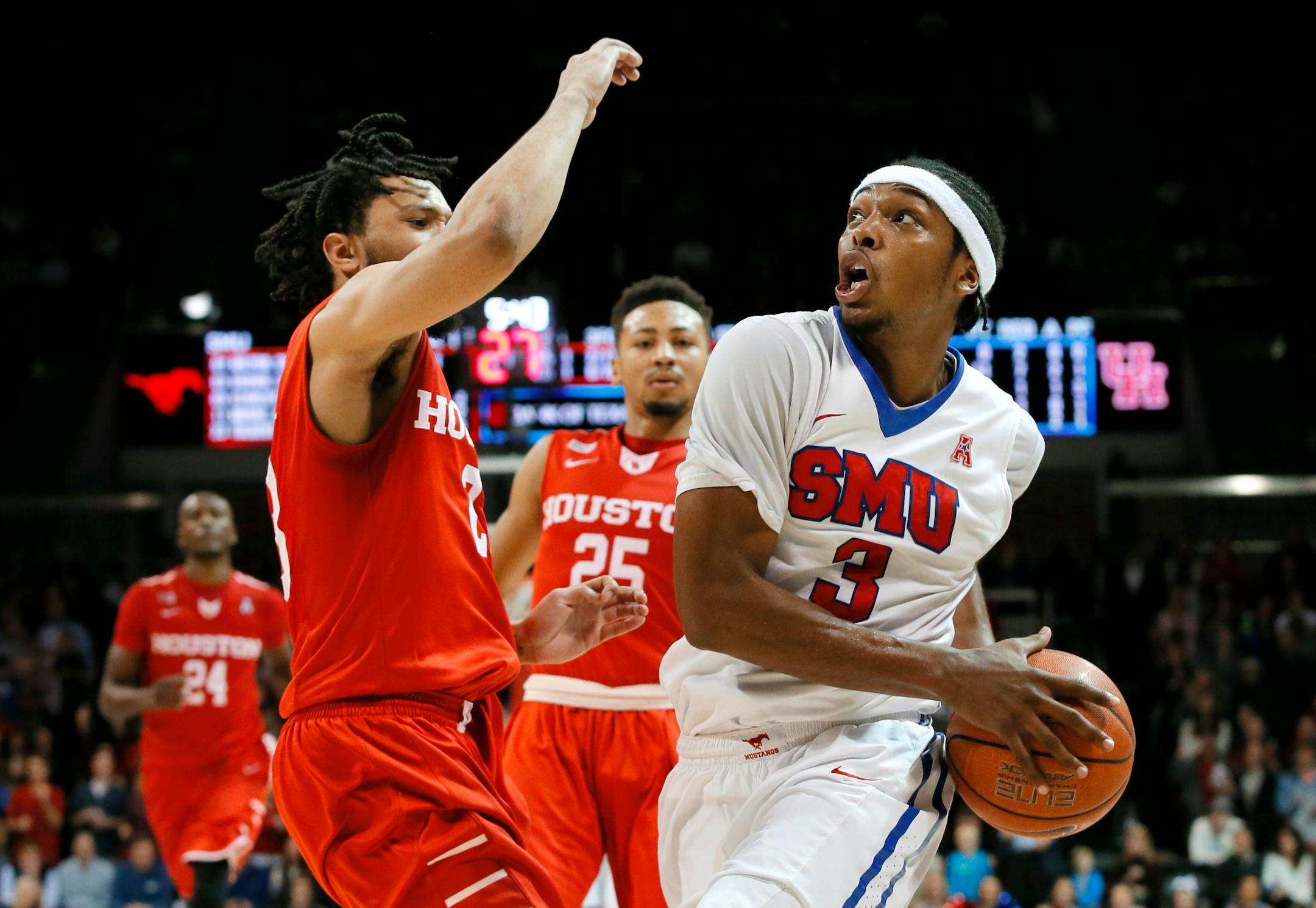 Houston guard Damyean Dotson defends as SMU guard Sterling Brown (3) positions for a shot in the second half of an NCAA college basketball game, Tuesday, Jan. 19, 2016, in Dallas. SMU won 77-73. (AP Photo/Tony Gutierrez)