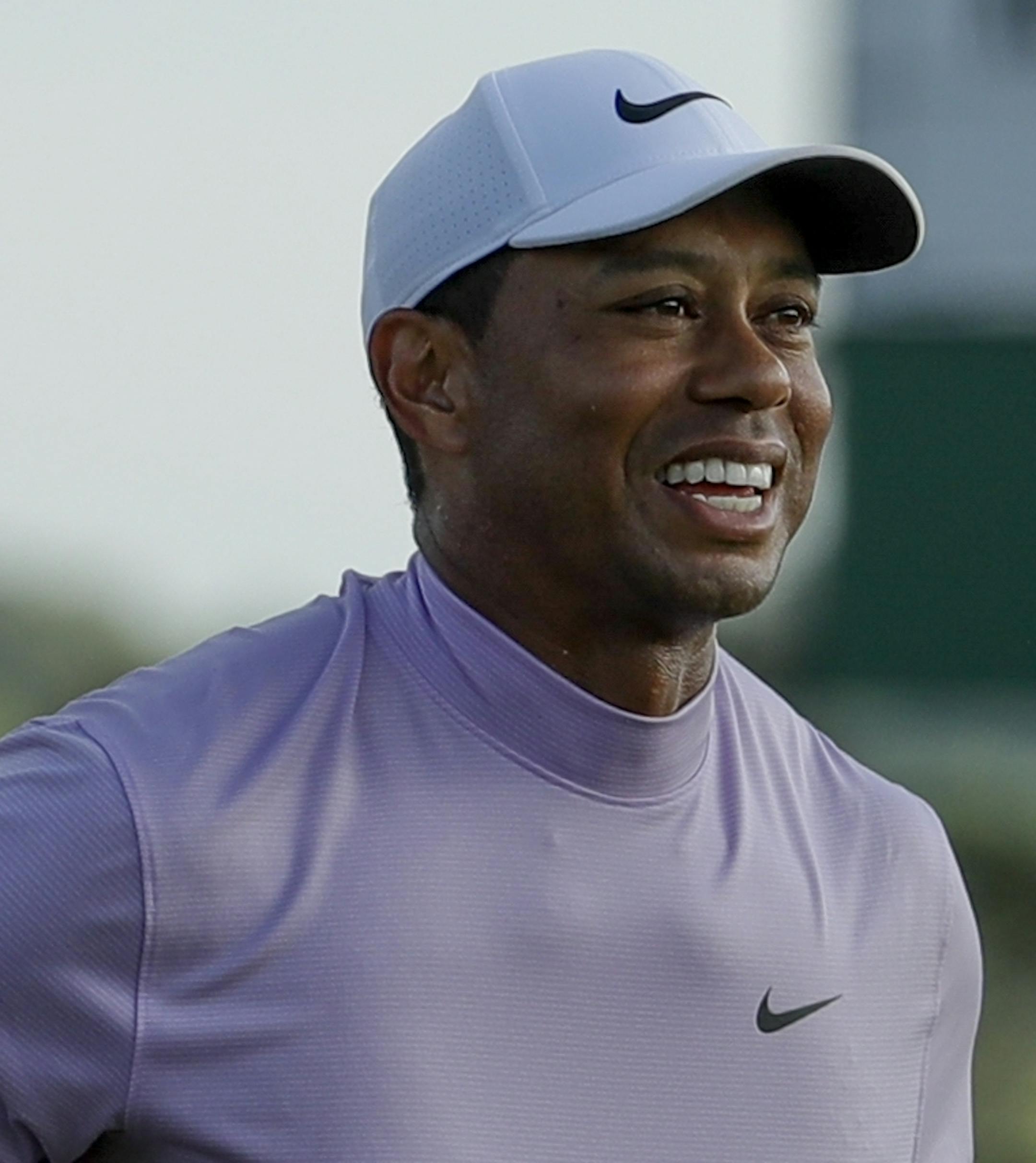 Tiger Woods smiles as he walks off the 18th green during the third round for the Masters golf tournament Saturday, April 13, 2019, in Augusta, Ga. (AP Photo/Chris Carlson)
