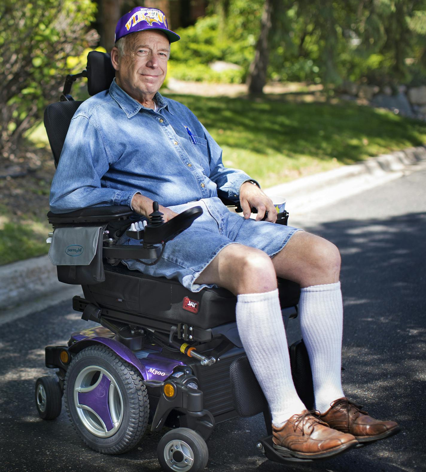 Lyle Franke, a diehard Vikings fan and former vendor at Vikings games, posed for a picture in his scooter, Vikings purple, on Thursday, May 21, 2015, in Bloomington, Minn. Franke has bought a commemorative brick to be displayed at the new Vikings stadium. ] RENEE JONES SCHNEIDER &#xd4; reneejones@startribune.com ORG XMIT: MIN1505211458151729