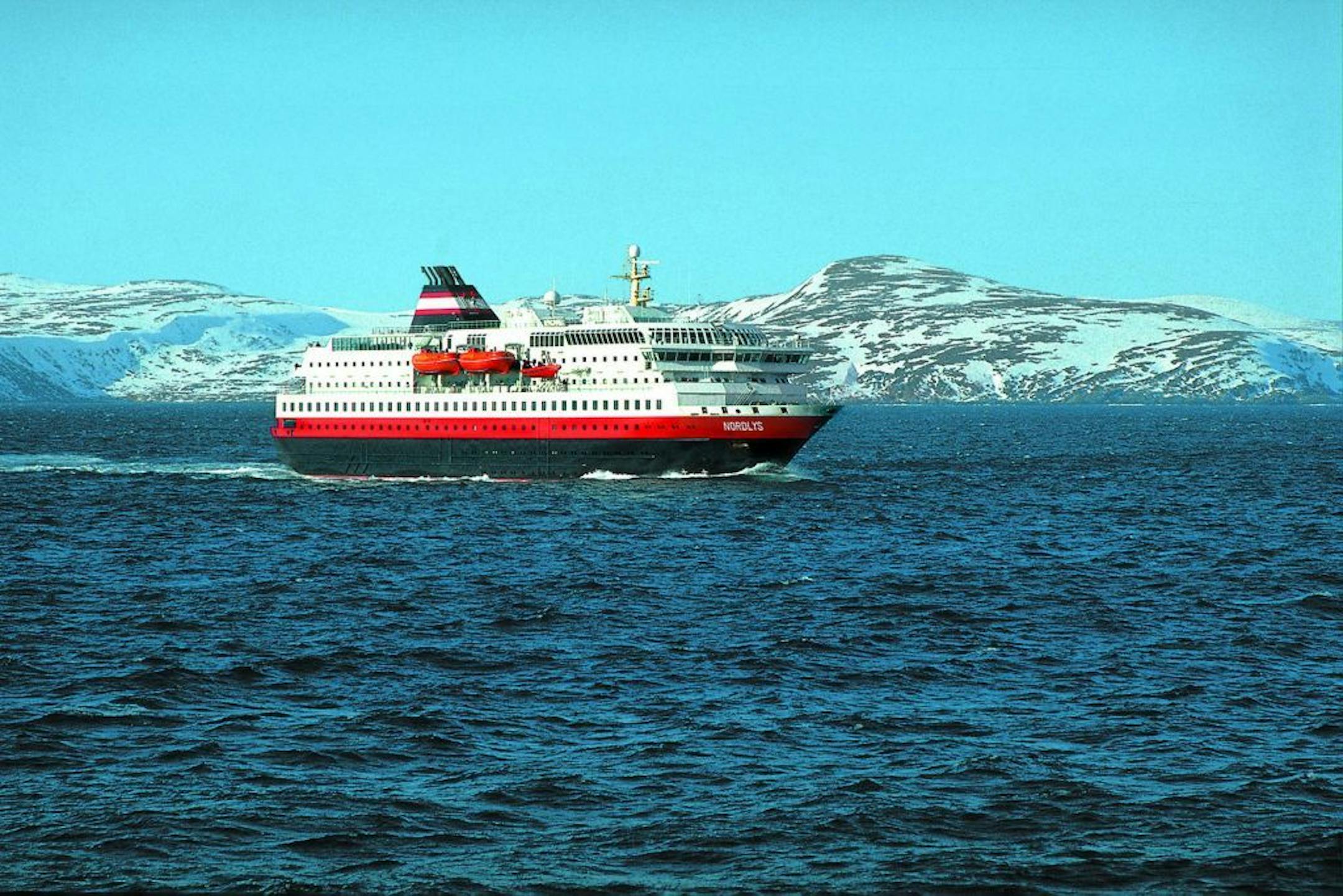 The MS Nordlys sailed past snow-capped mountains on the Norwegian coast. Dinners served aboard reflect locally available produce and cuisine.
