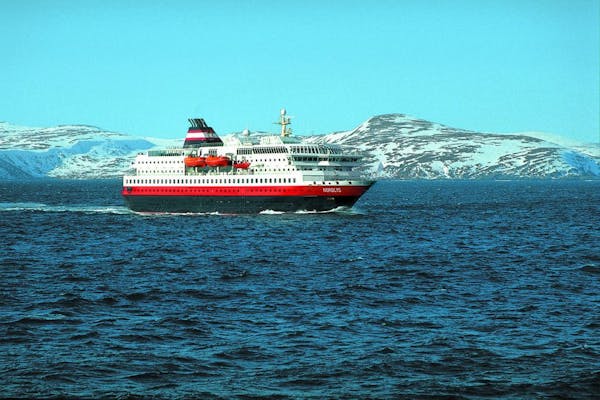 The MS Nordlys sailed past snow-capped mountains on the Norwegian coast. Dinners served aboard reflect locally available produce and cuisine.