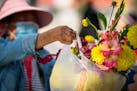 A vendor sold a fresh flower bouquet at the farmer’s market held in the parking lot of Sun Foods on University Avenue in St. Paul. The farmer’s ma