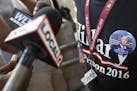 A supporter of Republican presidential candidate Donald Trump is interviewed by local media as he wears a "Hillary for Prison 2016" shirt before the a