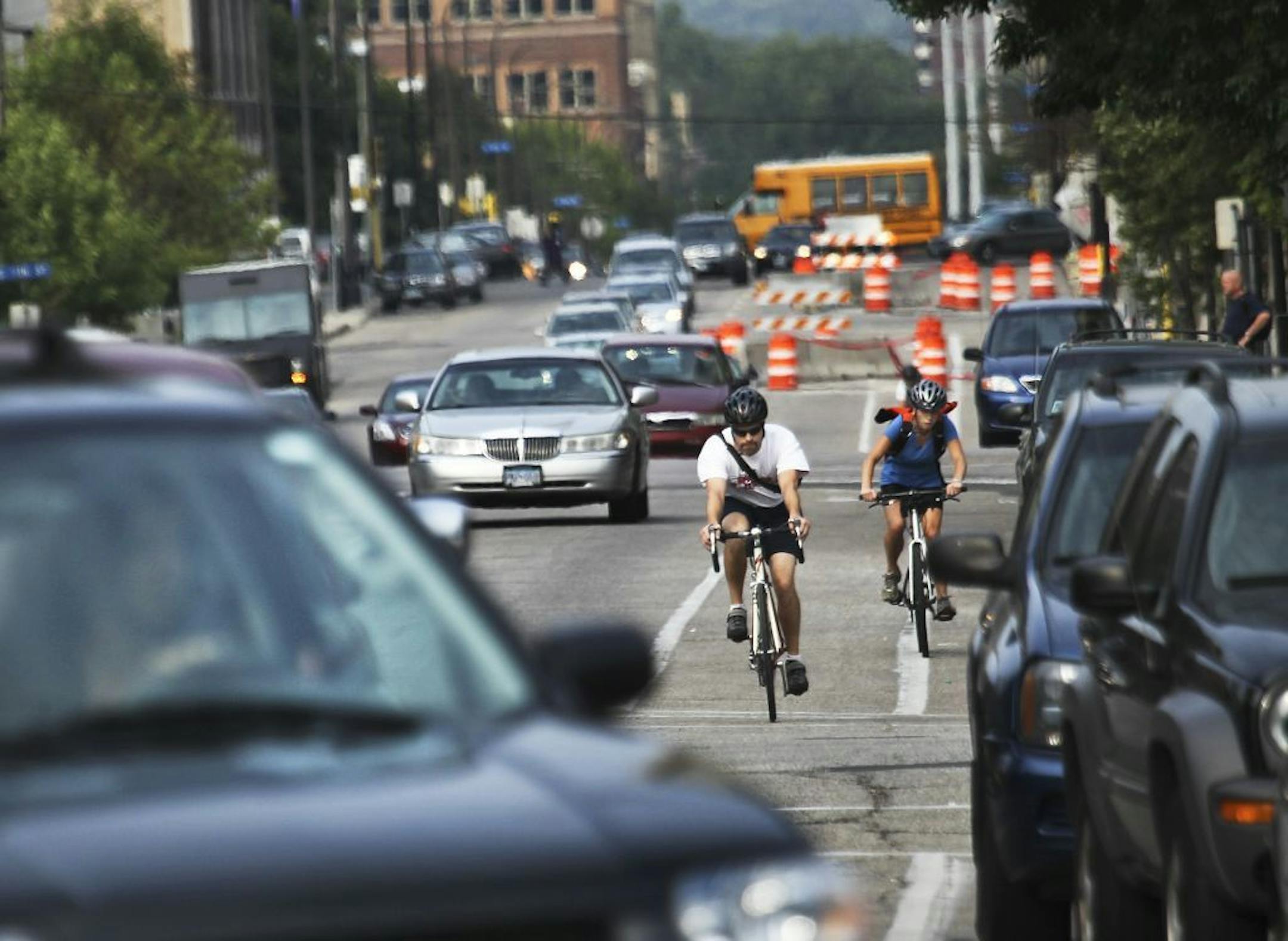 Bicyclists and cars co-exist while heading south in heavy traffic along Portland Ave., near E. Grant Street Thursday, Aug. 30, 2012, in Minneapolis, MN.