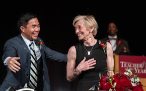 Kong Vang, an ethnic studies and exploring teaching instructor from Washington Technology Magnet School in St. Paul congratulates Linda Wallenberg, an