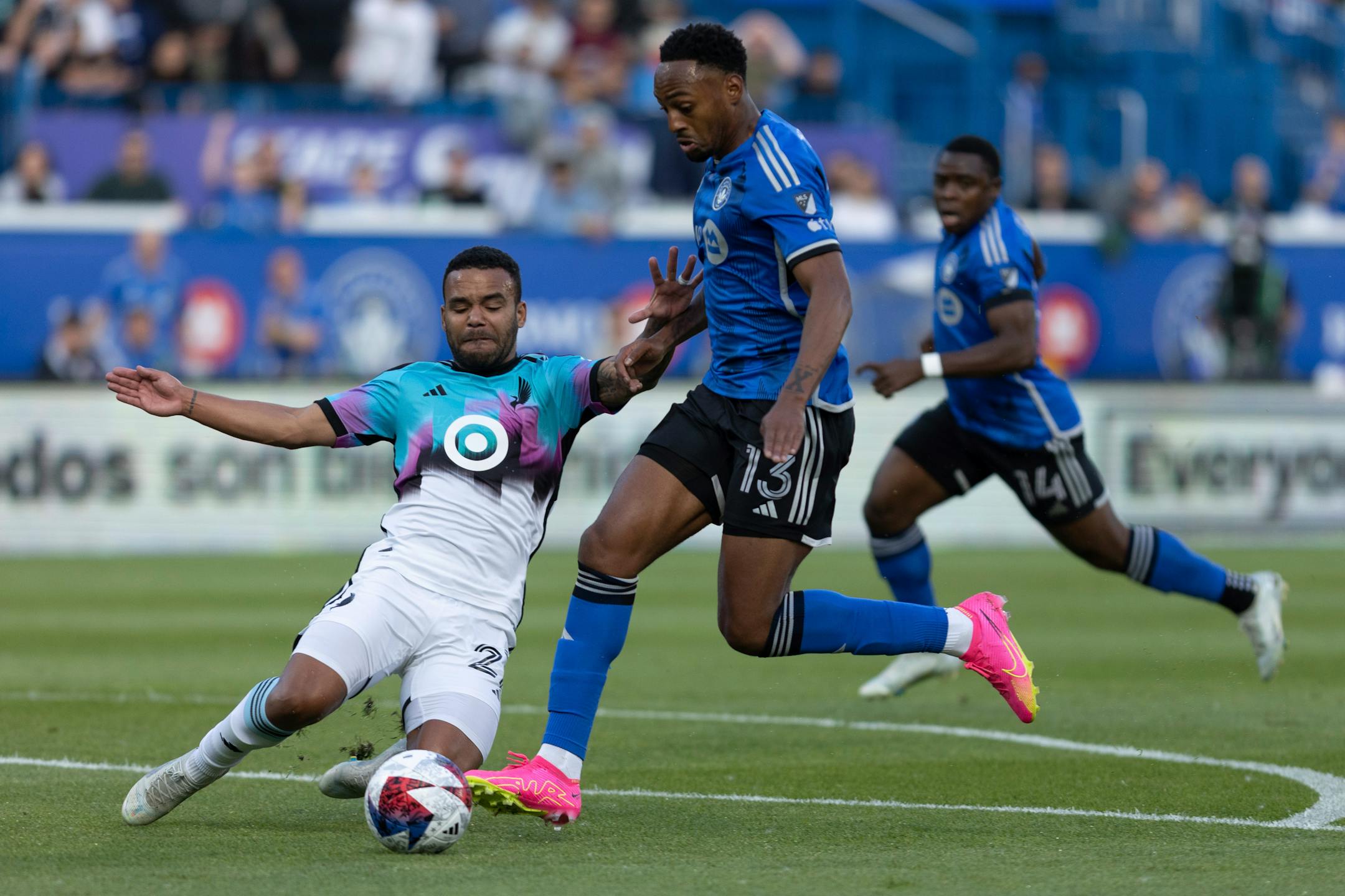 Minnesota United defender D.J. Taylor, left, slide-tackles CF Montreal forward Mason Toye during first-half Saturday. Toye scored twice