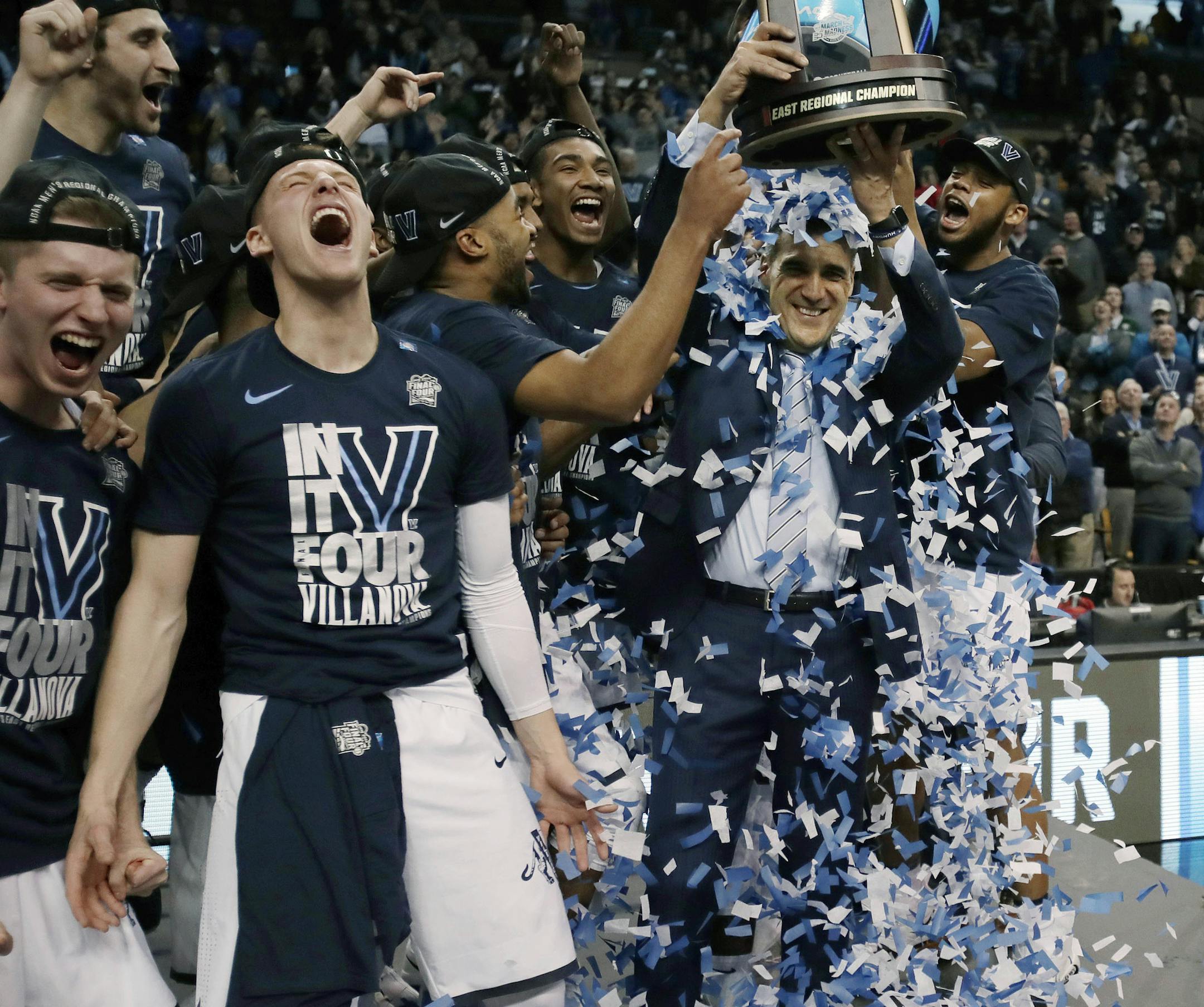 Villanova's Omari Spellman, right, dumps confetti on head coach Jay Wright, holding the trophy after their win over Texas Tech in an NCAA men's college basketball tournament regional final, Sunday, March 25, 2018, in Boston. Villanova won 71-59 to advance to the Final Four. (AP Photo/Charles Krupa)