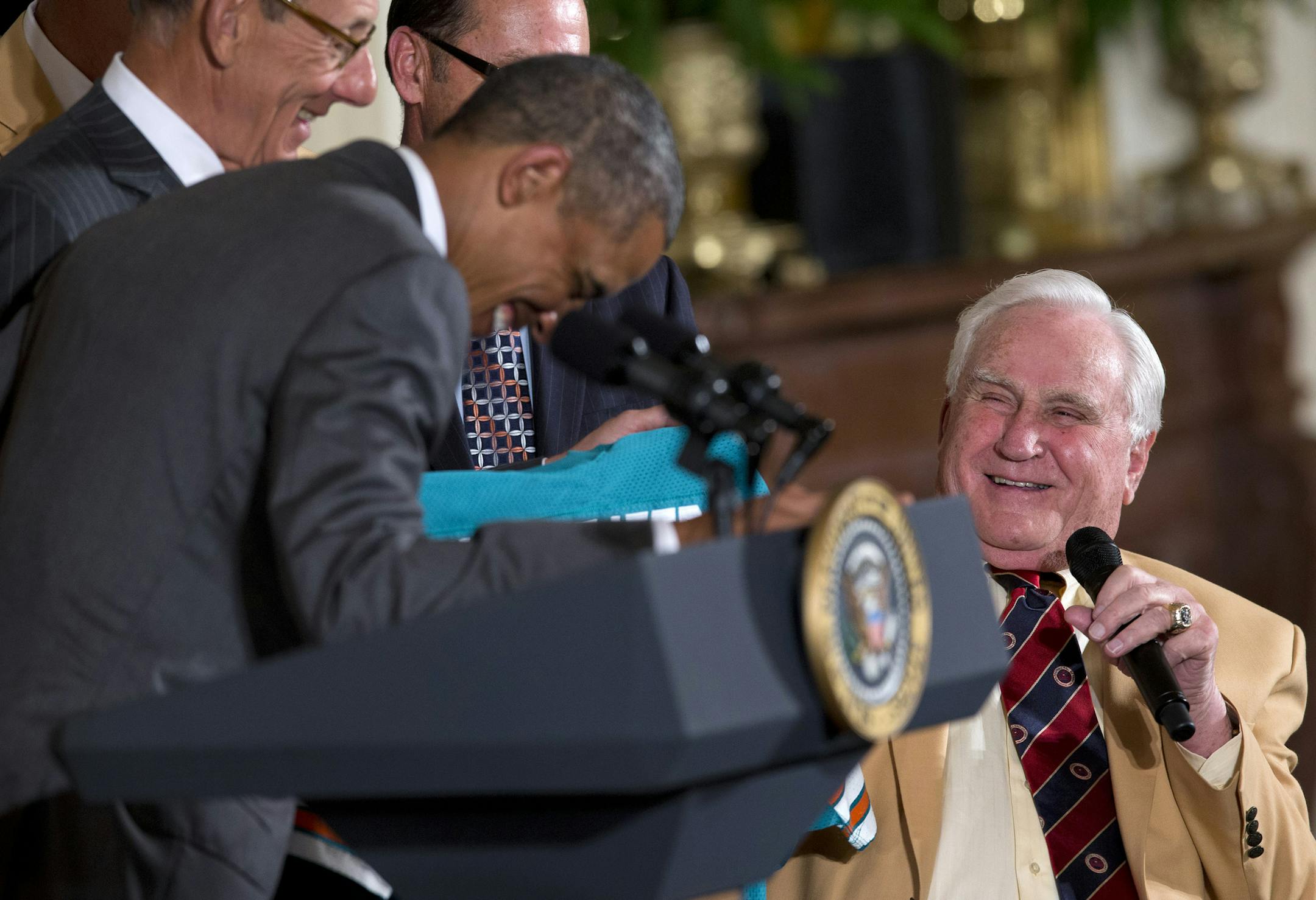 1972 Miami Dolphins head football coach Don Shula, right, shares a laugh with President Barack Obama, during a ceremony in the East Room of the White House in Washington, Tuesday, Aug. 20, 2013, where the president honored the Super Bowl VII football champion Miami Dolphins. The 1972 Miami Dolphins remain the only undefeated team in NFL history. (AP Photo/Evan Vucci)
