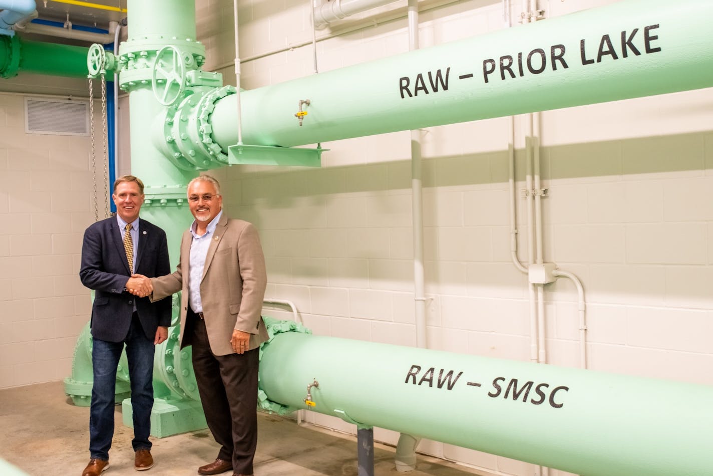 Prior Lake Mayor Kirt Briggs and Shakopee Mdewakanton Sioux Tribal Chairman Charles Vig pose for a picture inside the new water treatment center.