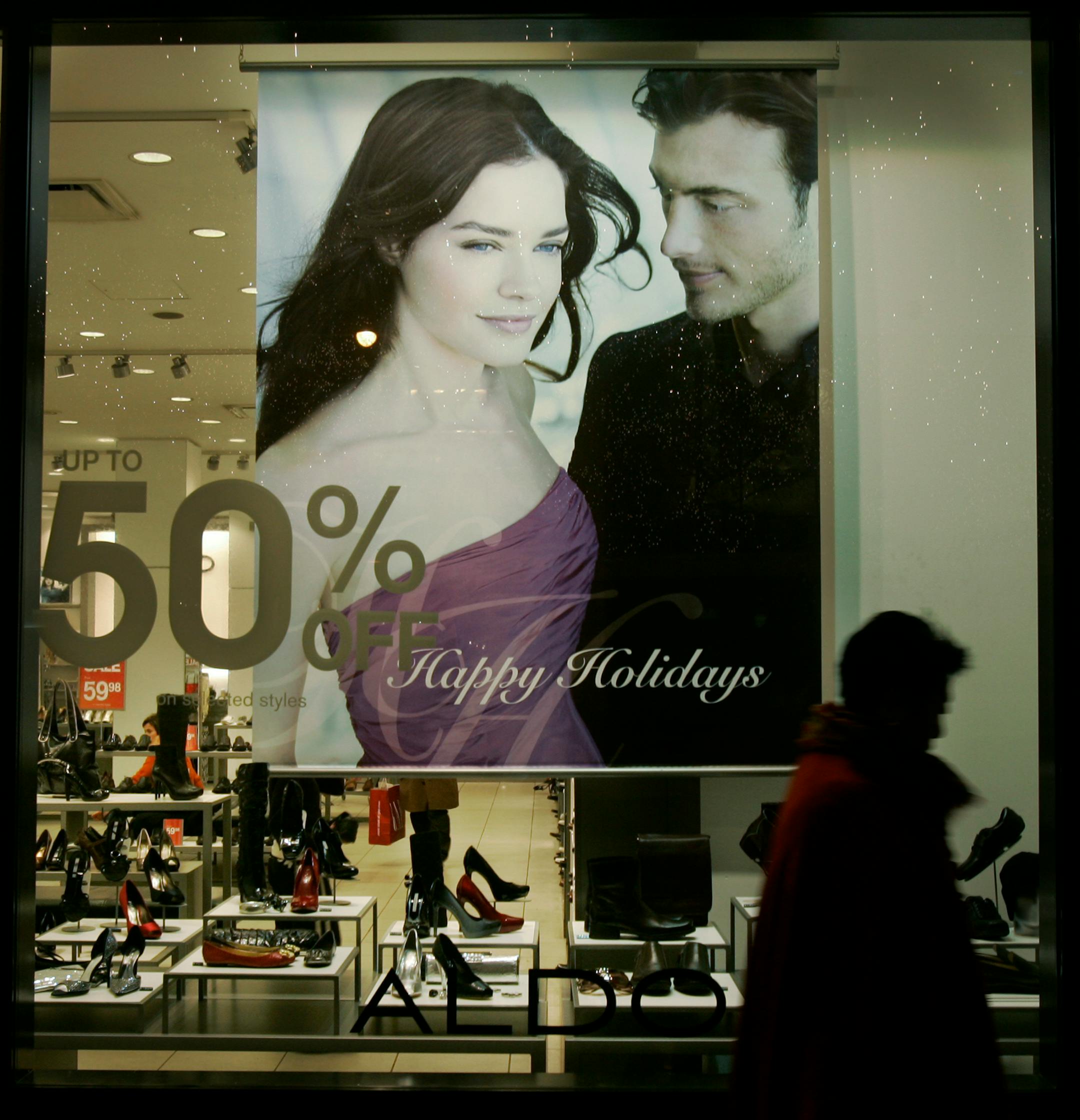 A holiday shopper walks past an ALDO shoe store on Chicago's Magnificent Mile, Thursday, Nov. 29, 2007. Consumers battered by a slumping housing market and a credit crunch slowed the growth in spending to the smallest amount in four months. (AP Photo/Charles Rex Arbogast)