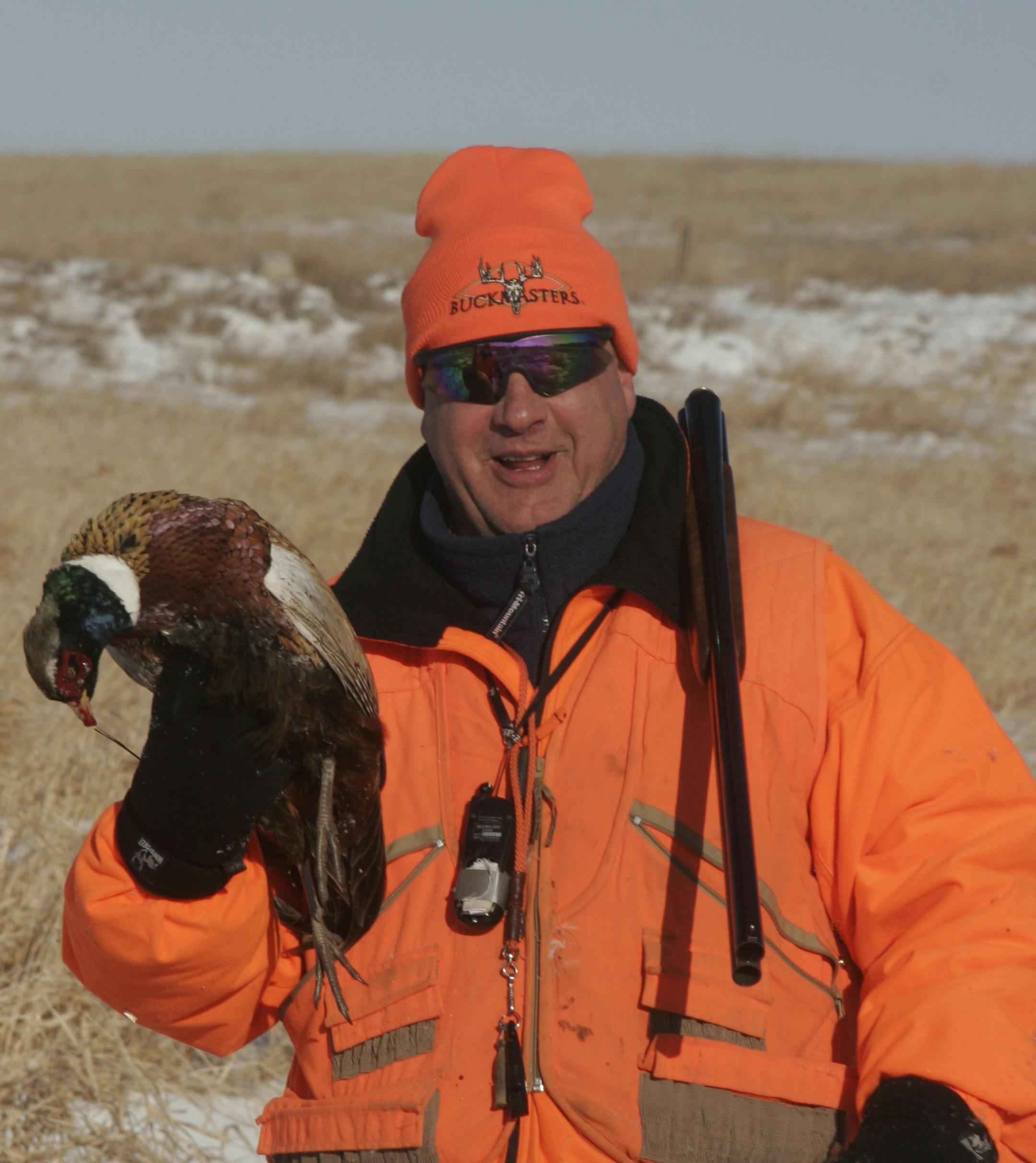 Mark Victor, 51, of Farmington holds a rooster he shot last weekend during a late-season pheasant hunt in western Minnesota.