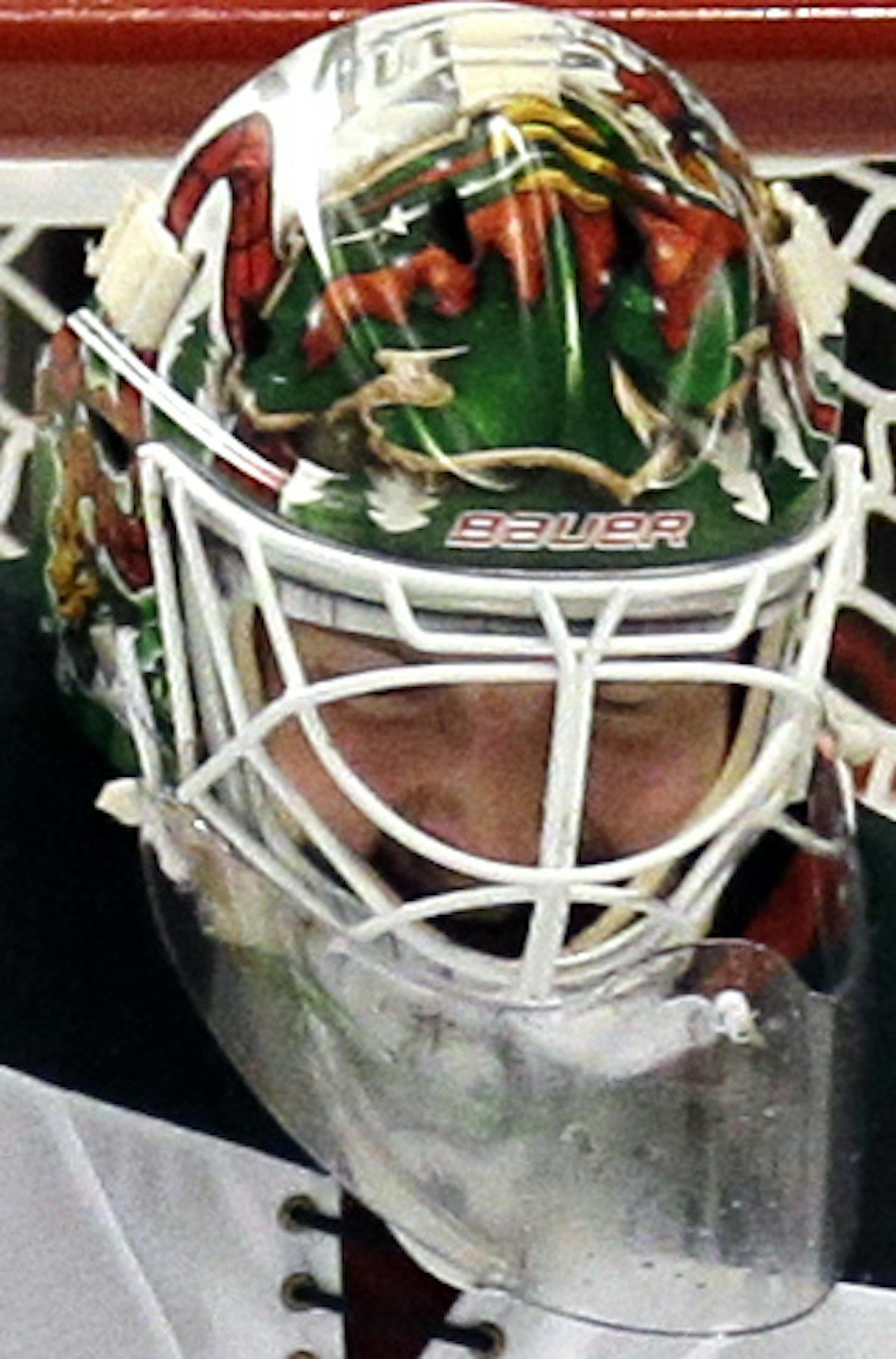 Minnesota Wild goalie Devan Dubnyk, left, fails to stop a shot and goal by Chicago Blackhawks center Jonathan Toews, right, during the second period of Game 2 in the second round of the NHL Stanley Cup hockey playoffs in Chicago, Sunday, May 3, 2015. (AP Photo/Nam Y. Huh)