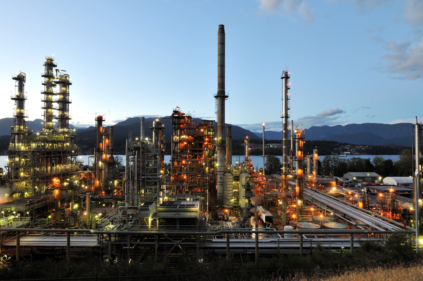 Oil refinery at night in Burnaby, British Columbia, Canada. Shortage of pipeline capacity is causing Canadian oil producers to discount their crude by as much as two-thirds.