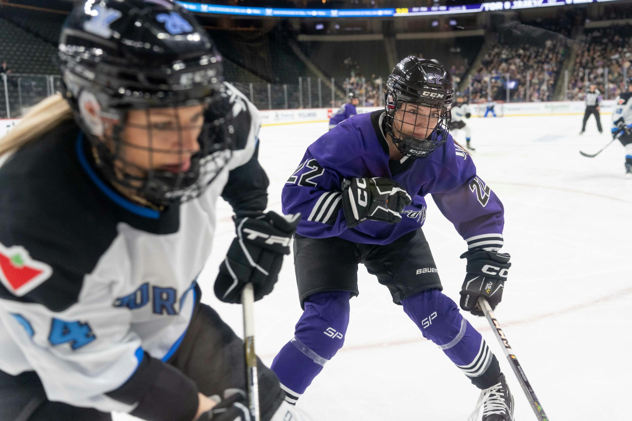 Minnesota defender Natalie Buchbinder (22) checks Toronto forward Natalie Spooner (24) in the first period between Minnesota and Toronto of the PWHL at the Xcel Energy Center in St. Paul on Wednesday, Jan. 10, 2024. Photo by Matt Blewett, Special to Star Tribune matt@mattebphoto.com