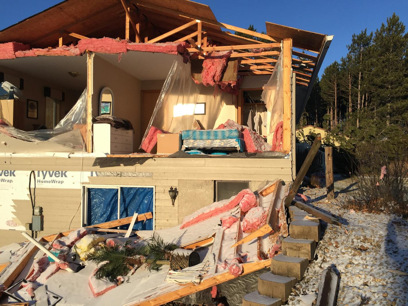 The side of a house in Orrock township, near Zimmerman, Minn., was sheared off by an apparent tornado Monday night.