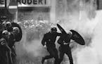 FILE - In this May 6 1968 file photo, anti-riot police charge through the streets of Paris during violent student demonstrations. Emmanuel Macron was 