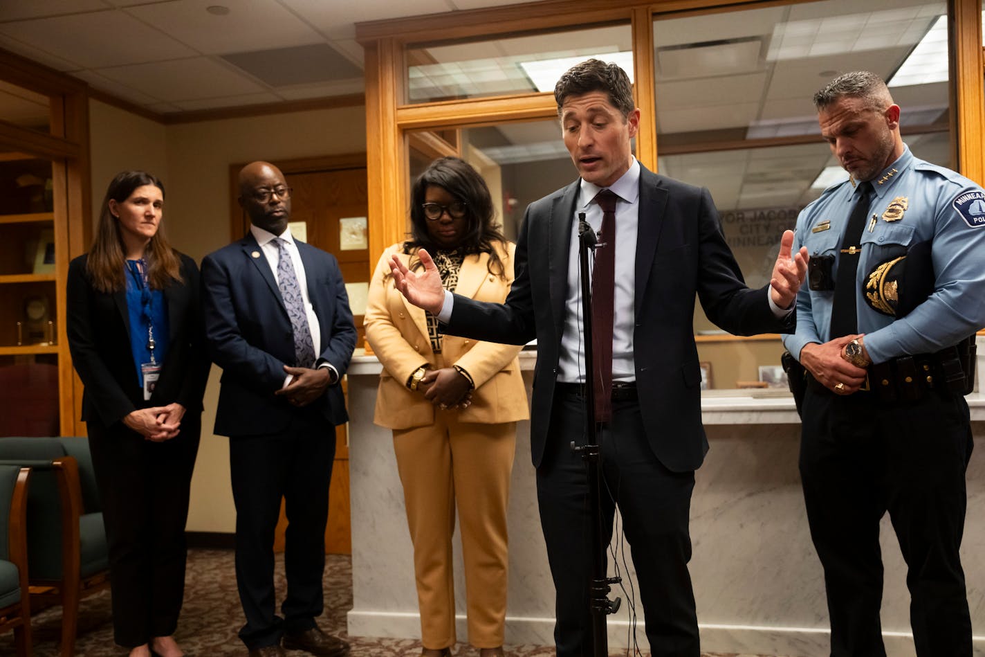 Minneapolis Mayor Jacob Frey reacted to the City Council voting Friday 8-5 to reject a $15 million plan to retain and recruit police officers at City Hall on Friday, Nov. 17, 2023 in Minneapolis, Minn. Behind him is Minneapolis Police Chief Brian O'Hara at right. ] RENEE JONES SCHNEIDER • renee.jones@startribune.com