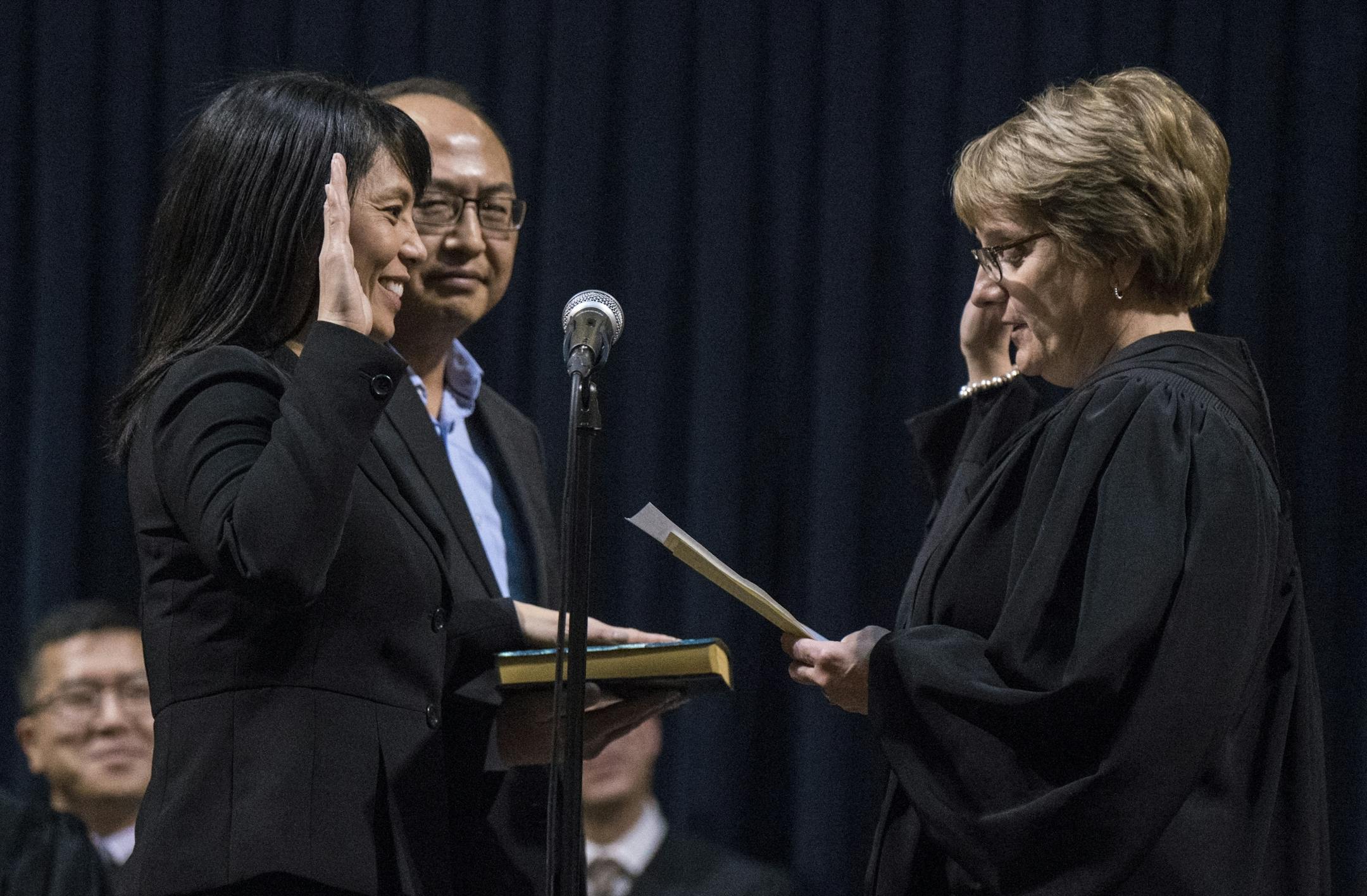 Sophia VueLo took the oath as Minnesota Second Judicial District Judge with her husband Dr. Muaj C. Lo next to her and Chief Justice Lorie Gildea administering the ceremony.