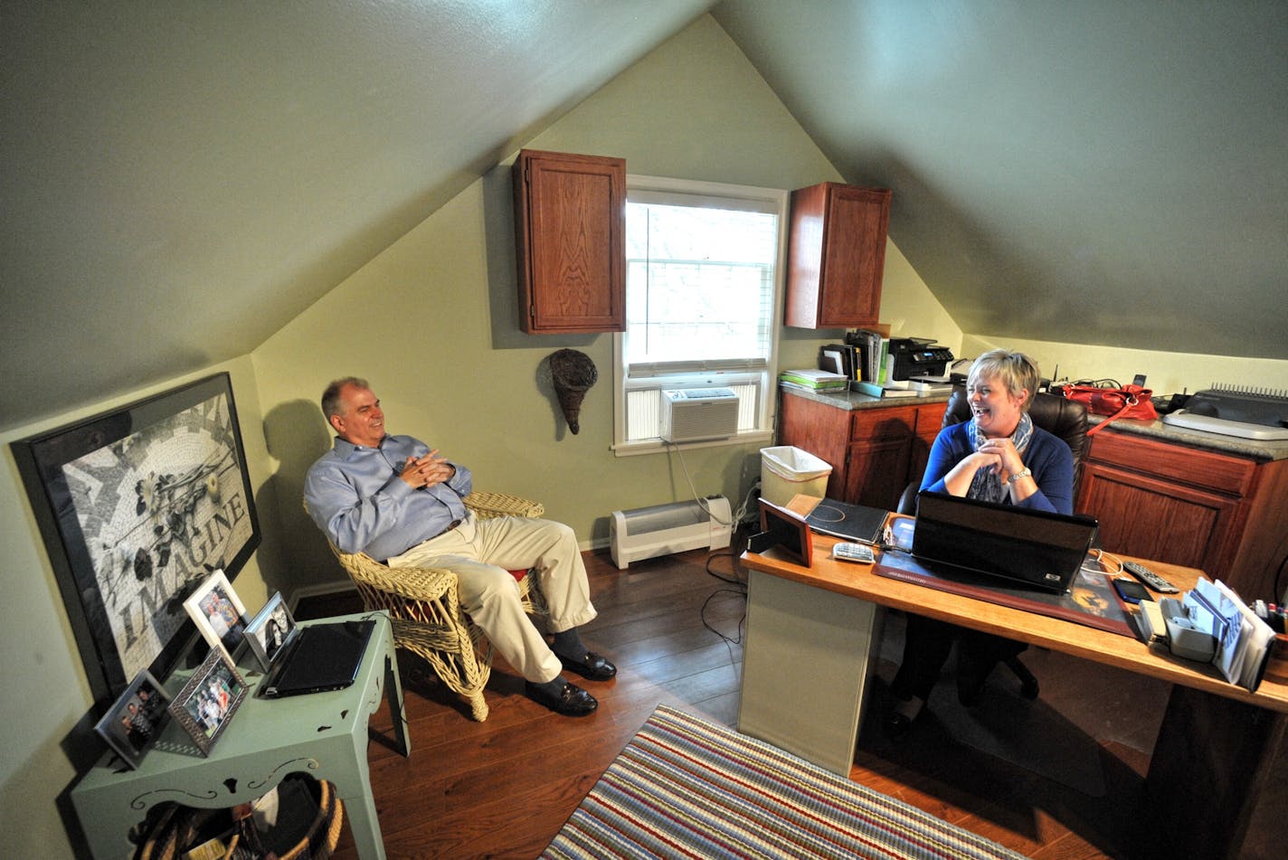 Fred and Kristi Gray Shepherd confer in her office, which is across the hall from his.