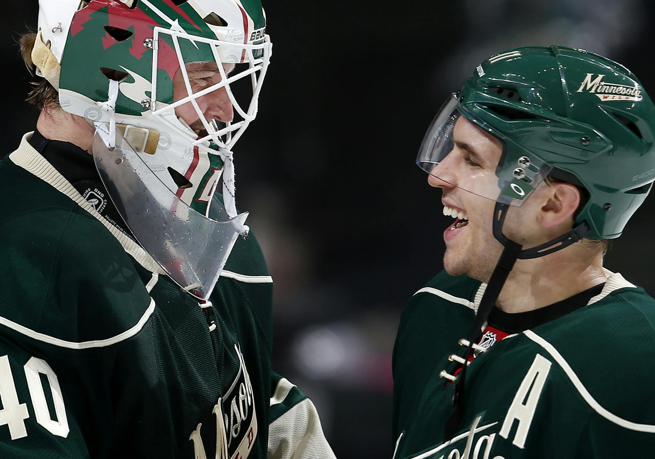 Minnesota Wild goalie Devan Dubnyk (4) and Zach Parise celebrated at the end of the game. Minnesota beat Chicago by a final score of 3-0. ] CARLOS GONZALEZ cgonzalez@startribune.com, February 3, 2015, St. Paul, Minn., Xcel Energy Center, NHL, Minnesota Wild vs. Chicago Blackhawks ORG XMIT: MIN1502041426180093