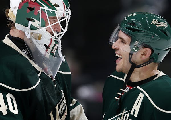 Minnesota Wild goalie Devan Dubnyk (4) and Zach Parise celebrated at the end of the game. Minnesota beat Chicago by a final score of 3-0. ] CARLOS GON