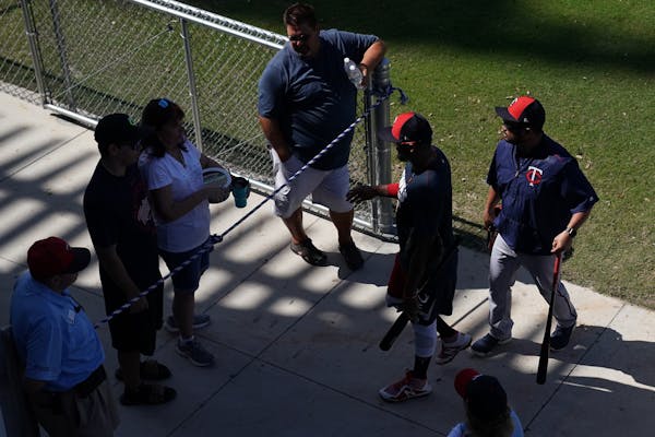 Minnesota Twins players signed autographs for fans on their way to the clubhouse following workouts Friday morning.