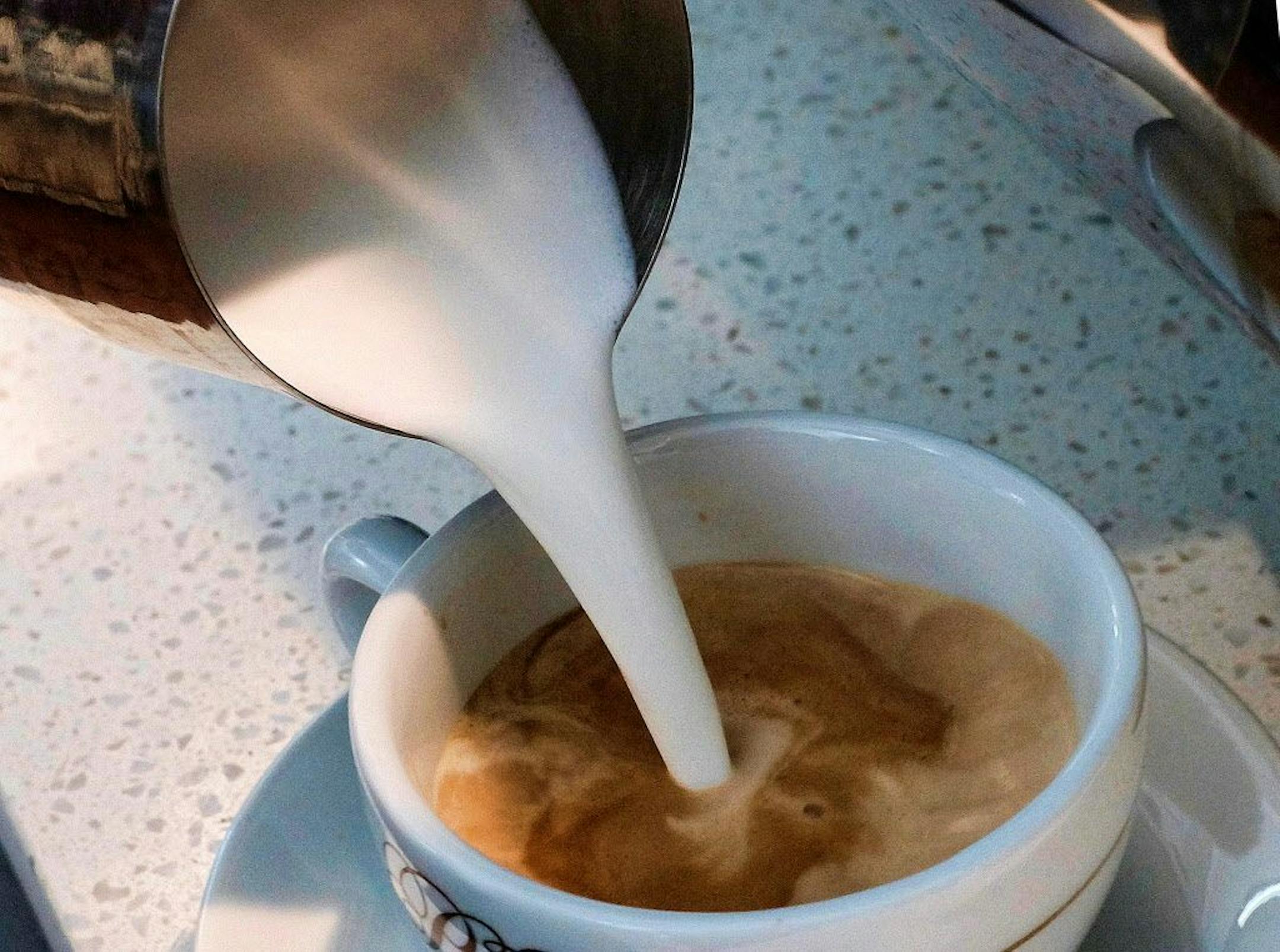 FILE - In this Sept. 22, 2017, file photo, a barista pours steamed milk in a coffee at a cafe in Los Angeles.