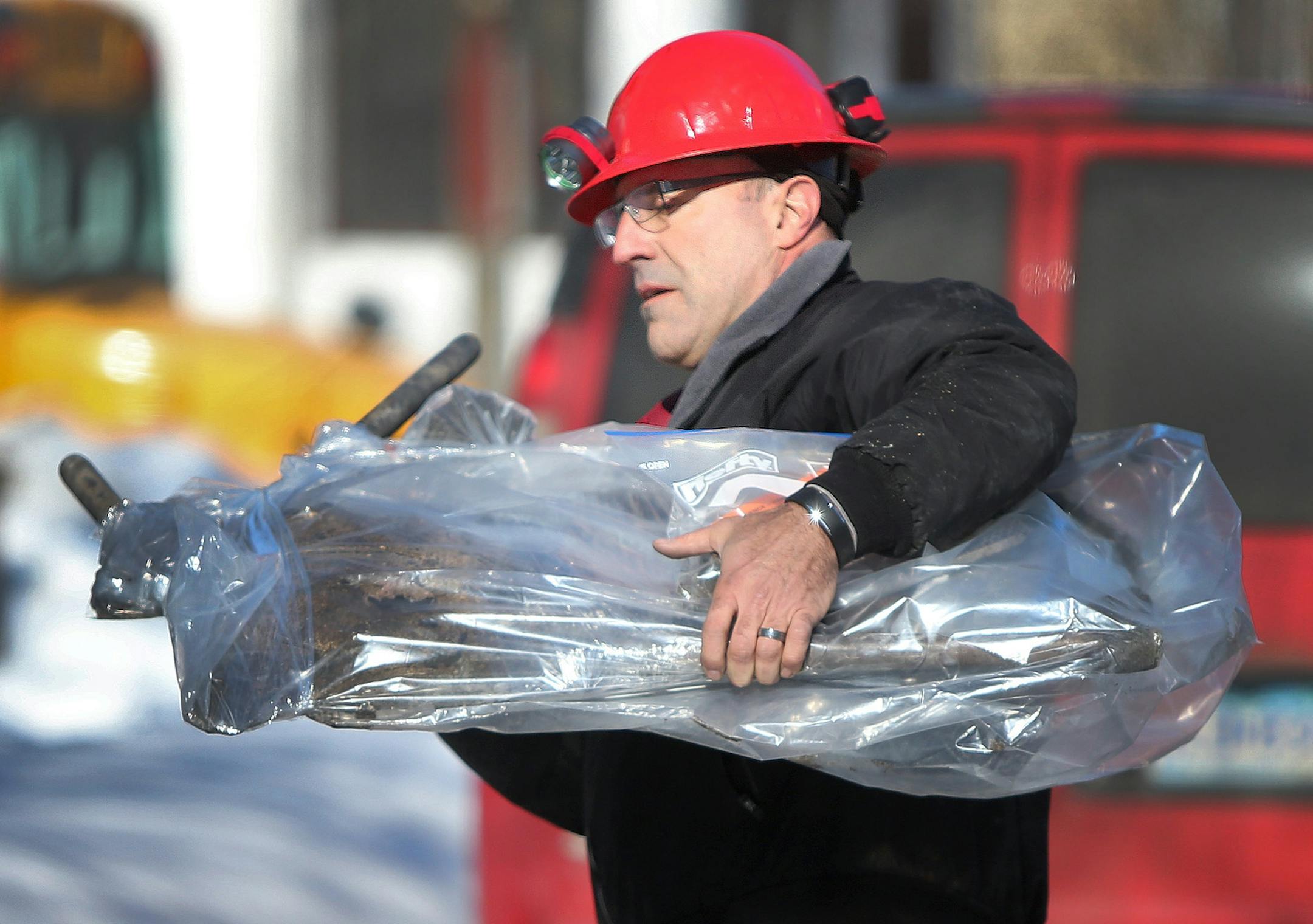 Dan Choudek, a a forensic engineer with Onsight Engineering, removed the remains of a space heater from the home on Colfax Avenue North where five children died in a house fire, Wednesday, February 19, 2014 in Minneapolis.