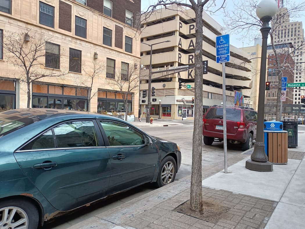 One of the cars occupying two new disabled parking spaces outside St. Paul City Hall appeared to be parked illegally Wednesday.