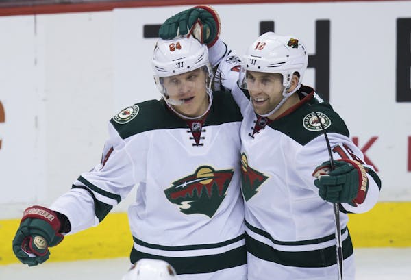 Linemate Jason Zucker, right, was the first to congratulate Mikael Granlund after Granlund completed his hat trick Saturday night.