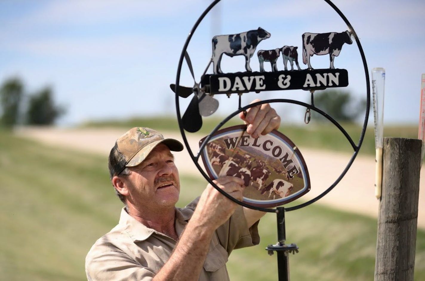 Dave Buck, who has farmed all his life, instructed each of his and wife Ann's six children to work outside farming when they graduated high school before deciding whether or not to make farming a career. Here, Buck fixed a sign where one piece had come loose on the farm where they milk 500 cows twice daily and grow crops on 1,000 acres of land.