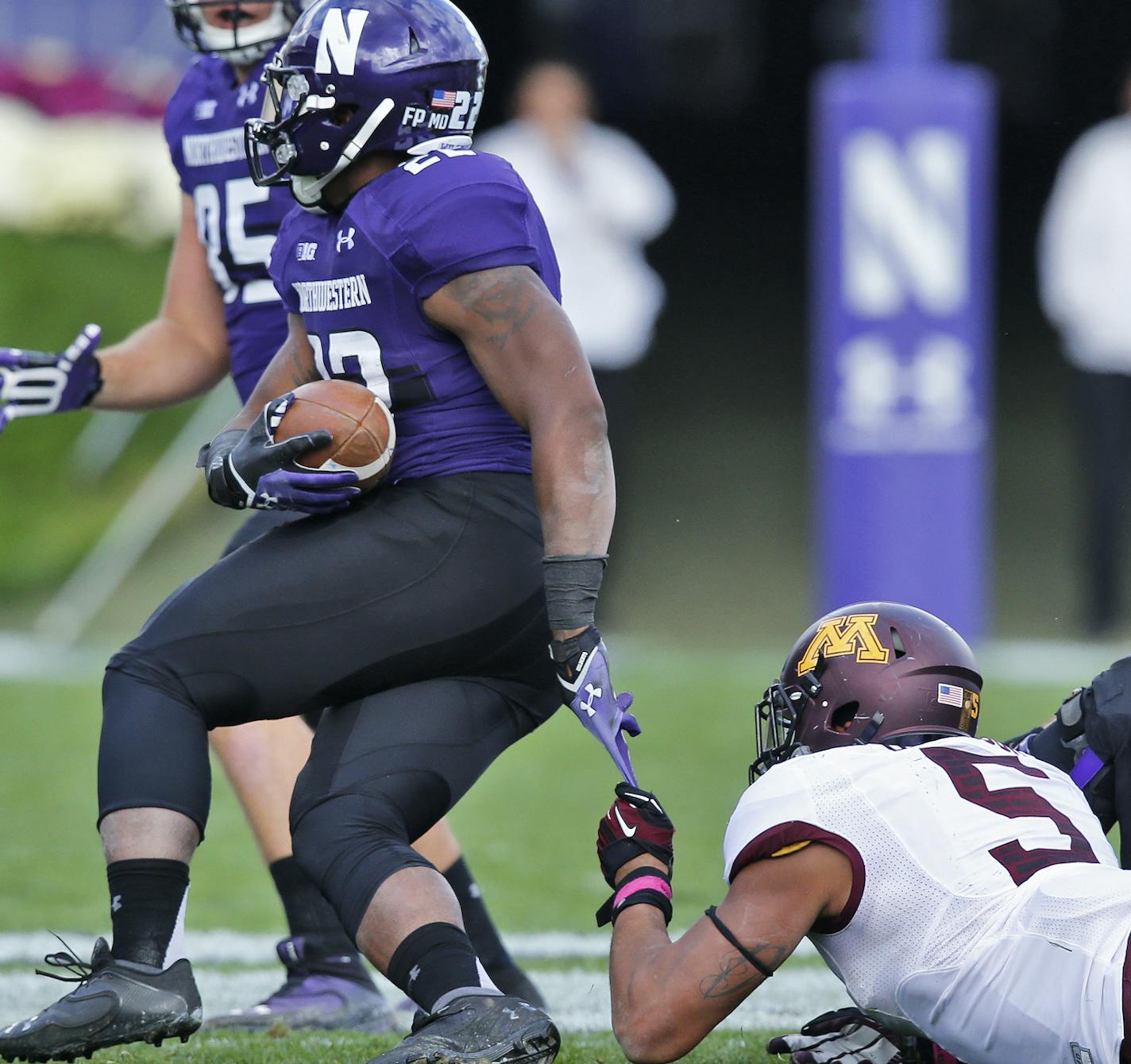 Minnesota Gophers vs. Northwestern Wildcats football. Minnesota won 20-17. Minnesota defender Damien Wilson (5) held on to the tip of Northwestern running back Treyvon Green's glove as he waited for teammates' help on the tackle. . (MARLIN LEVISON/STARTRIBUNE(mlevison@startribune.com)