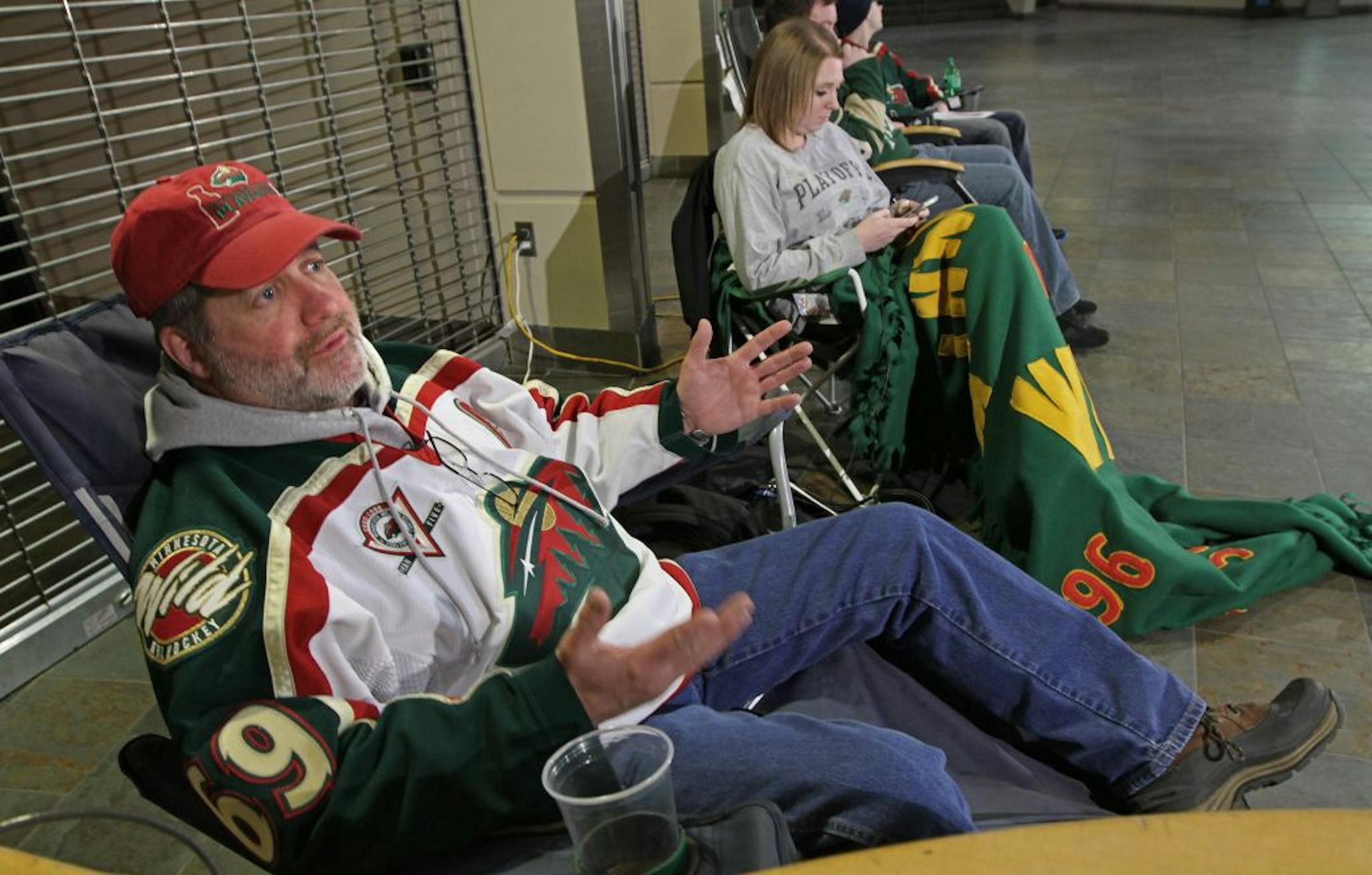 Pat Vos of South Minneapolis, left, and Jess Crane of Maple Grove were the first two in line, camping out in the Xcel Energy Center lobby for Wild single game tickets that go on sale Wednesday morning.