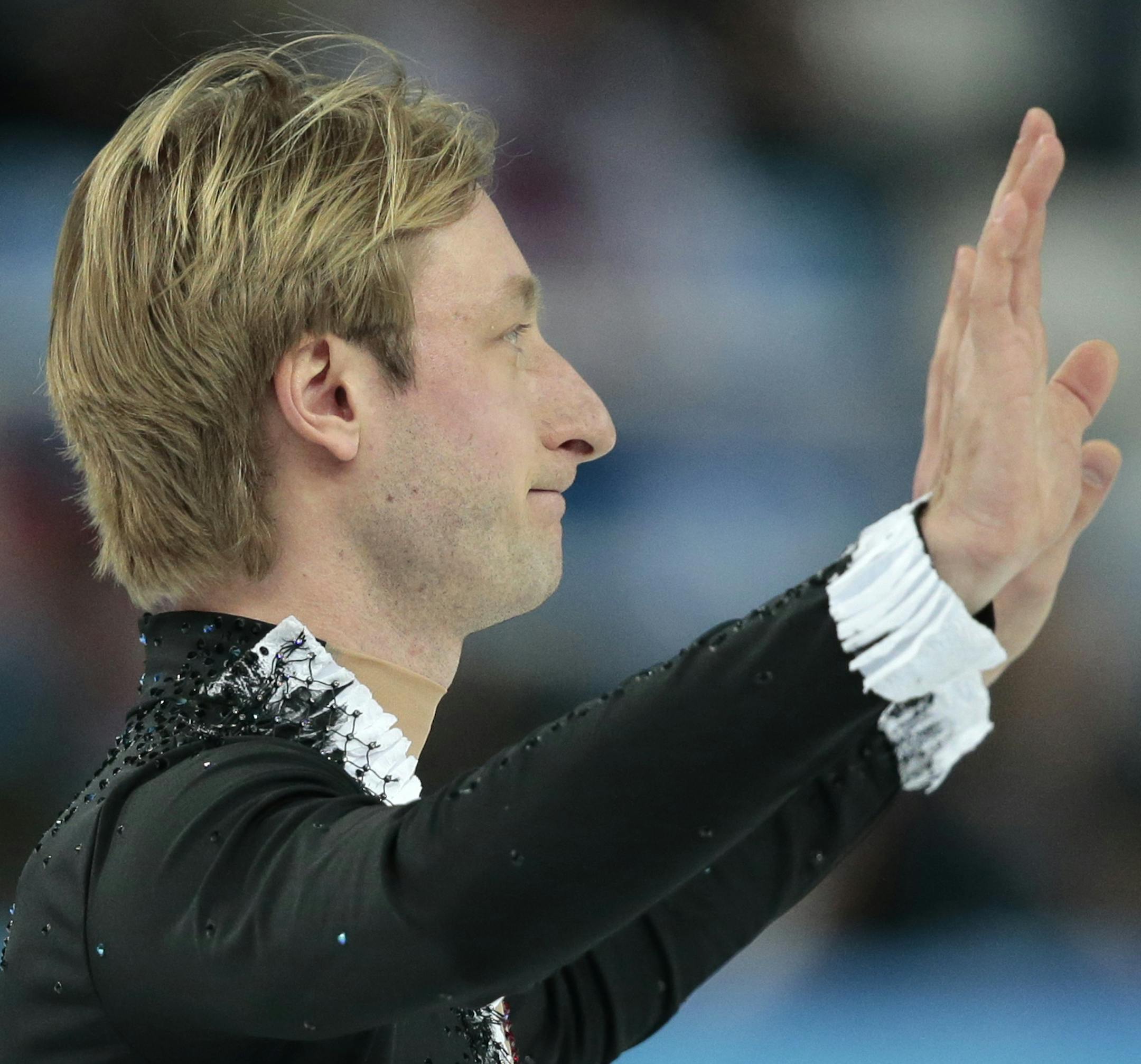 Evgeni Plushenko of Russia waves to spectators after he pulled out of the men's short program figure skating competition due to illness at the Iceberg Skating Palace during the 2014 Winter Olympics, Thursday, Feb. 13, 2014, in Sochi, Russia. (AP Photo/Ivan Sekretarev)