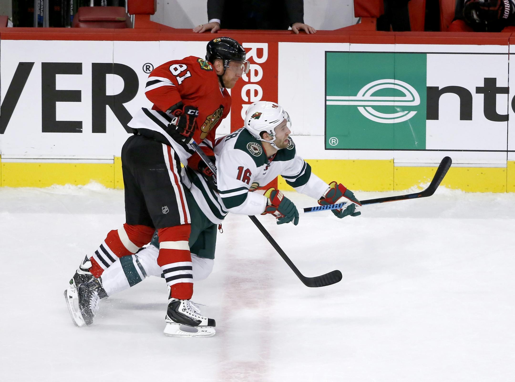Chicago Blackhawks right wing Marian Hossa (81) checks Minnesota Wild left wing Jason Zucker (16) during the first period of an NHL hockey game Tuesday, Dec. 1, 2015, in Chicago. (AP Photo/Charles Rex Arbogast)