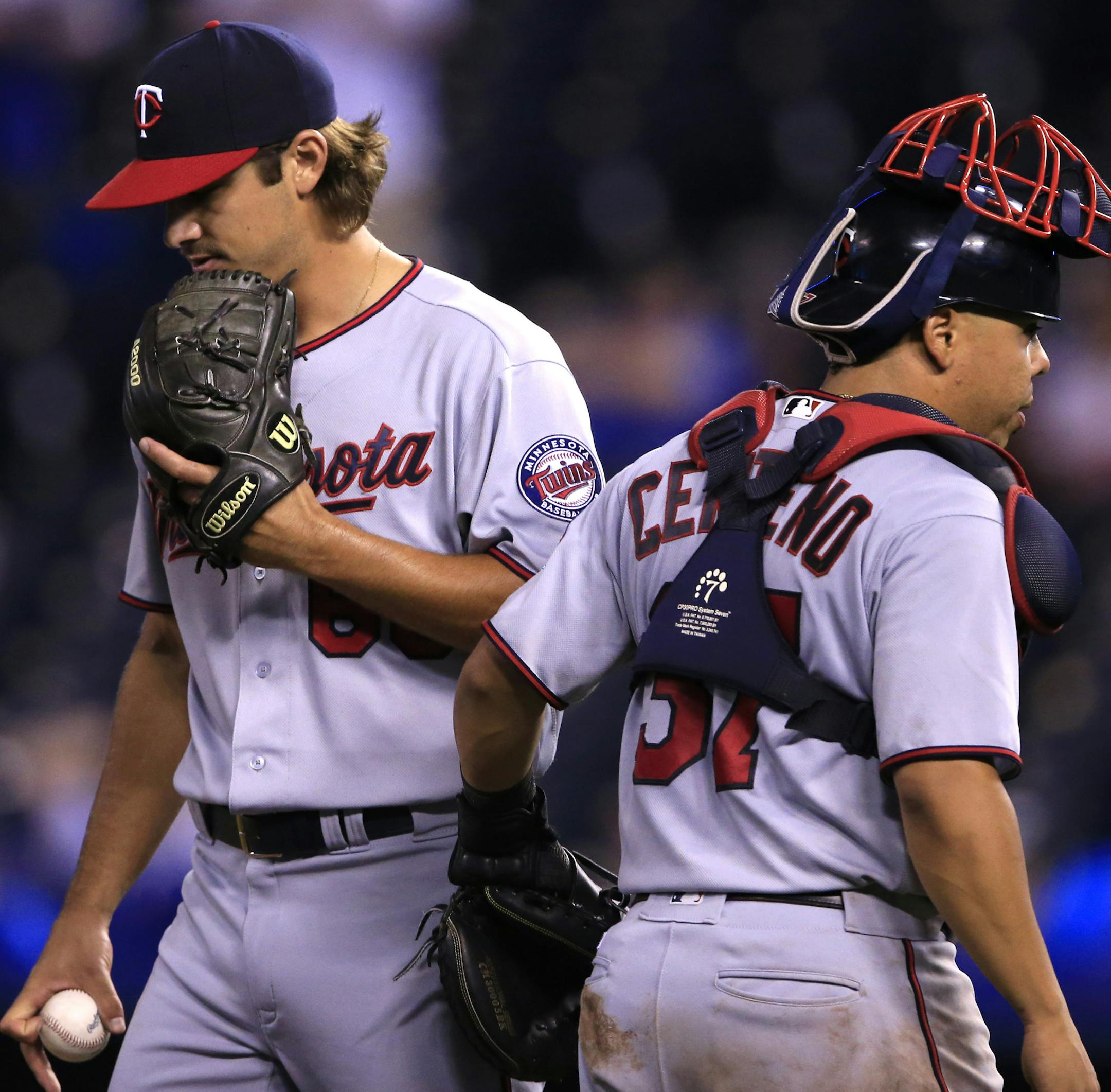 Minnesota Twins relief pitcher J.T. Chargois, left, talks with catcher Juan Centeno (37) during the 11th inning of a baseball game against the Kansas City Royals at Kauffman Stadium in Kansas City, Mo., Saturday, Aug. 20, 2016. The Royals defeated the Twins 5-4 in 11 innings. (AP Photo/Orlin Wagner)