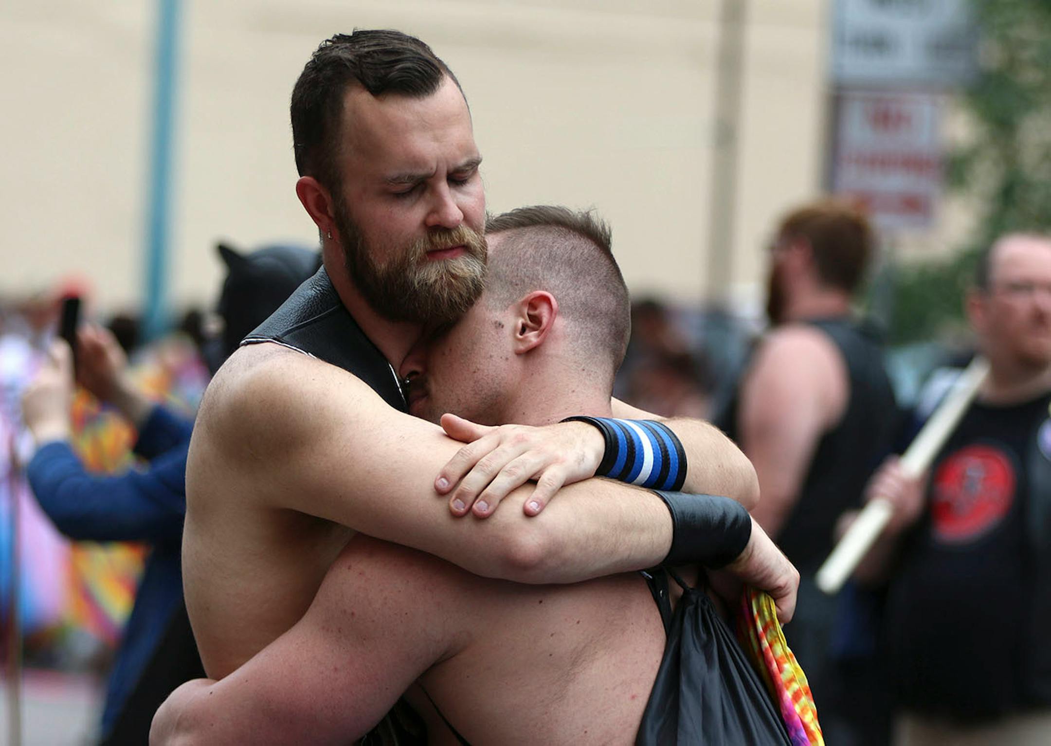 (Left) Magnus Wynter embraces Cody Marino during the pride parade, Sunday, June 24 2018.