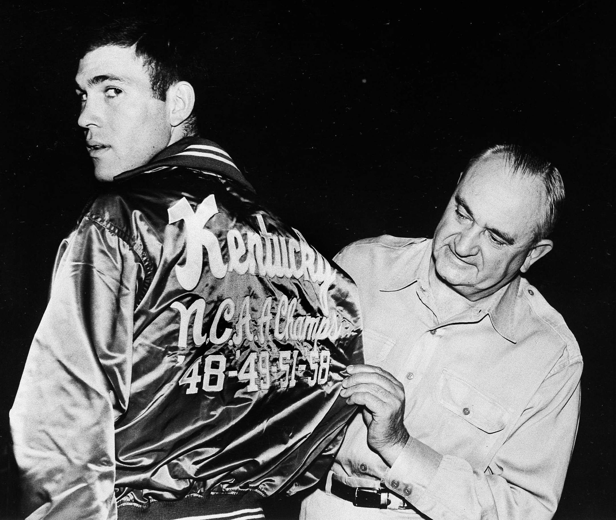 University of Kentucky coach Adolph Rupp looks at the back of Johnny Cox's jacket, Dec. 1, 1958. Kentucky has won four NCAA championships, in 1948, '49, '51, and '58. (AP Photo) ORG XMIT: APHS88436