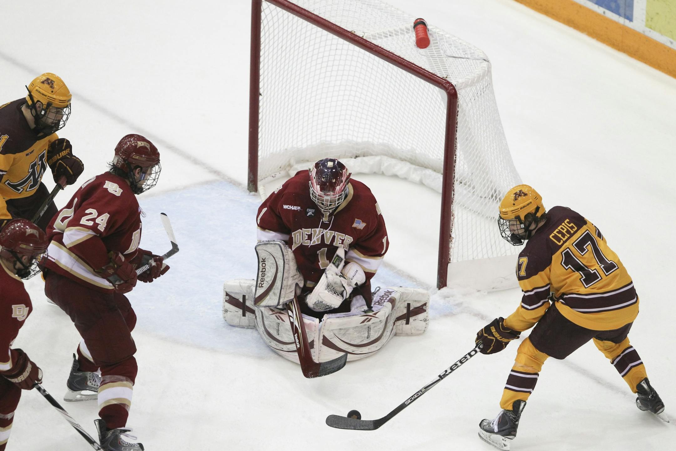 The Gophers' Jacob Cepis tried to get a second period shot off after he grabbed a rebound off of Denver goaltender Sam Brittain Friday night.