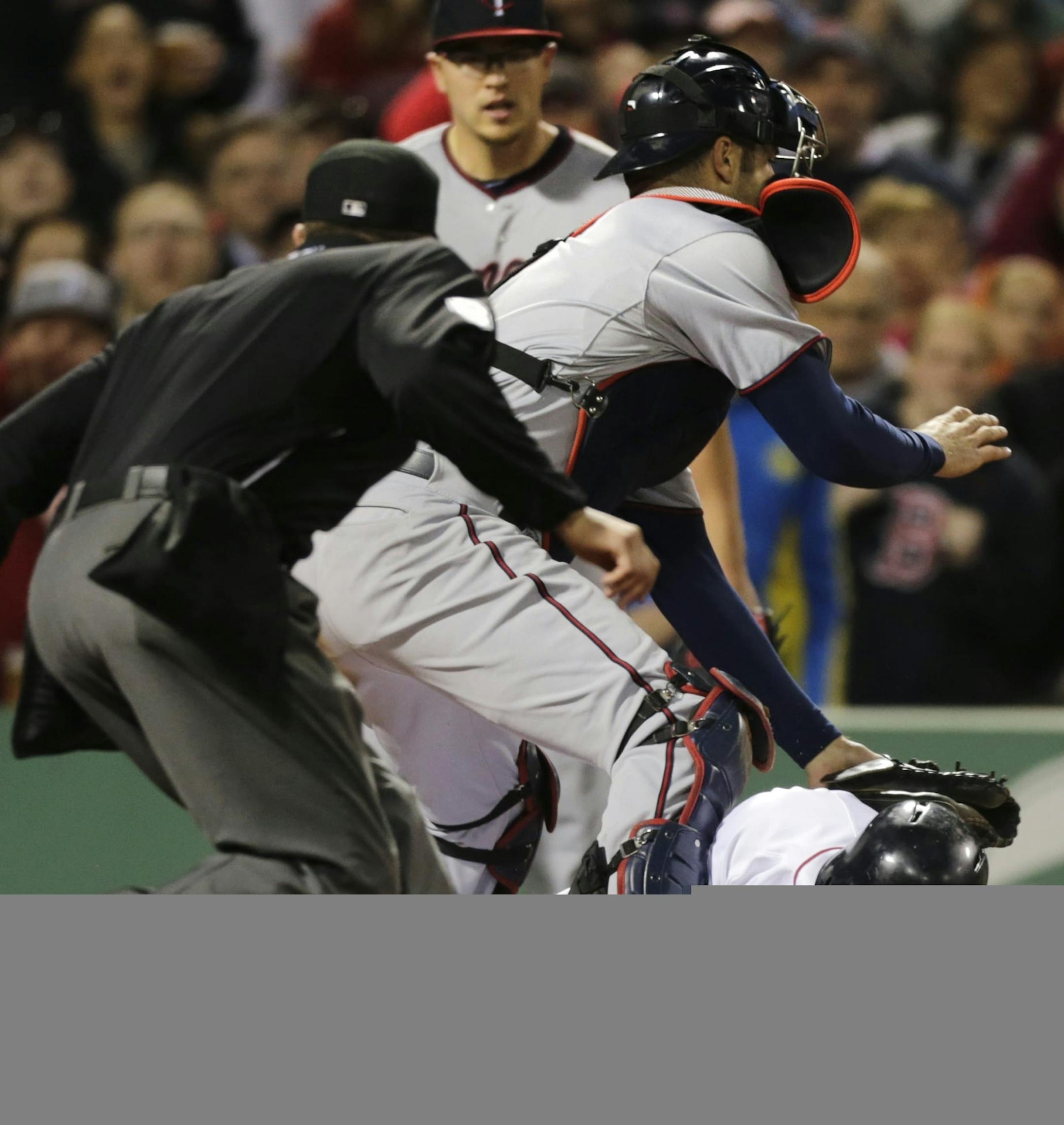 Boston Red Sox's Stephen Drew, bottom, tries to beat a tag by Minnesota Twins catcher Joe Mauer on a double by Jacoby Ellsbury during the fifth inning of a baseball game at Fenway Park in Boston, Monday, May 6, 2013. Drew was out on the play. At left is home plate umpire Cory Blaser. (AP Photo/Charles Krupa)