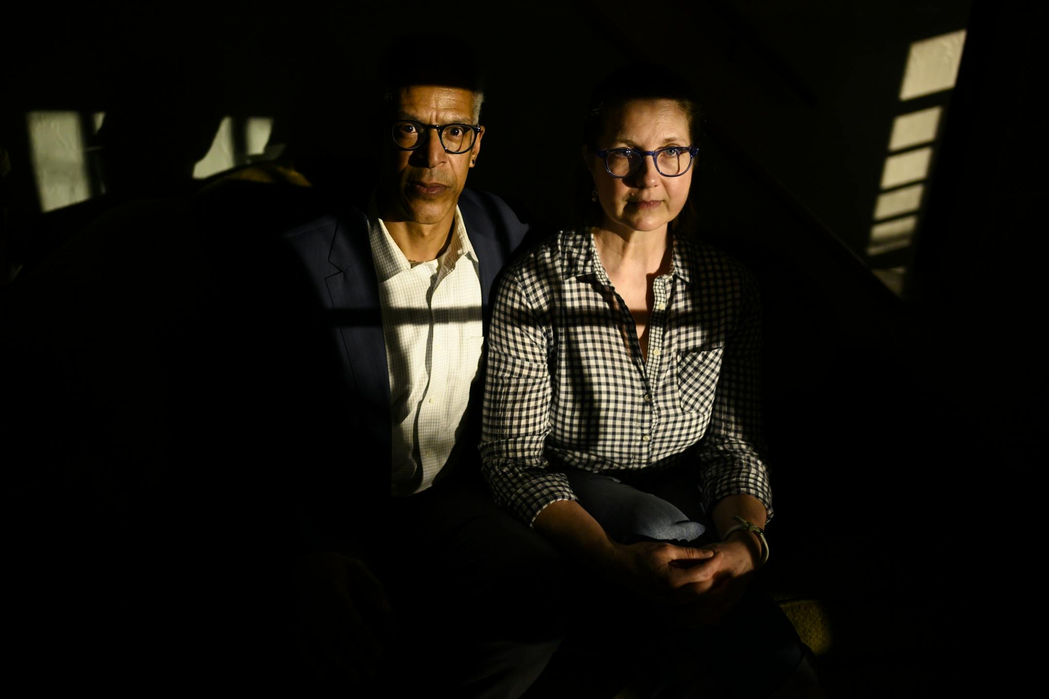 Chris Robinson and his wife Margaret Miller sat for a portrait in a slit of light coming in through their living room window being emitted by new Xcel streetlights outside their south Minneapolis home Wednesday night.