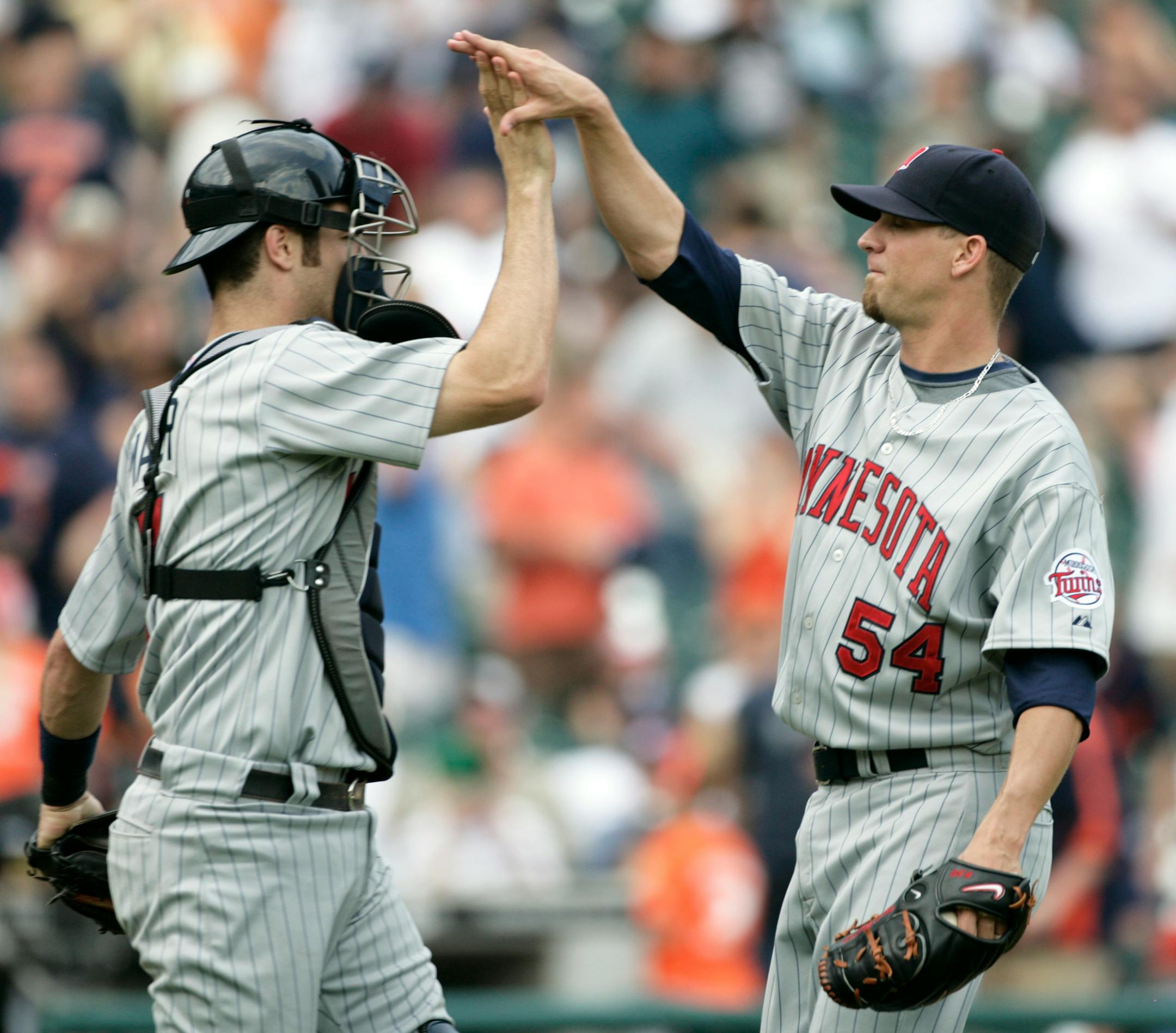 Minnesota Twins pitcher Matt Guerrier, right, and catcher Joe Mauer high-five after the Twins beat the Detroit Tigers 7-6 in 11 innings of a baseball game Thursday, July 10, 2008 in Detroit.
