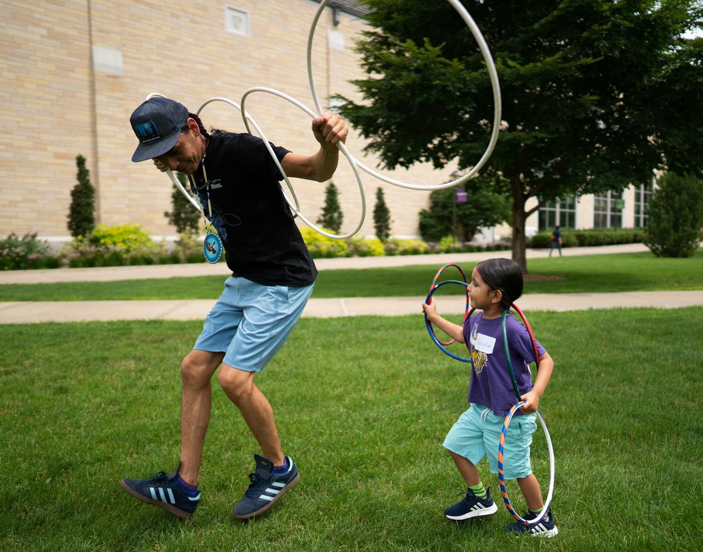 Micco Sampson and son, Nokose Sampson, 4, demonstrate a traditional Native American hoop dance. (ThreeSixty Journalism/Mark Vancleave)