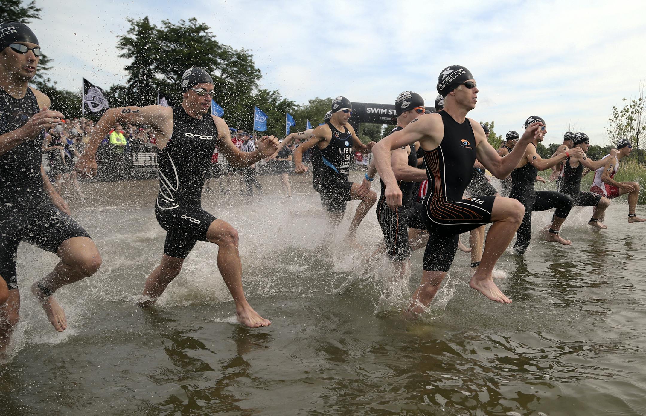 Pro male winner Cameron Dye, center, never trailed as he led swimmers into the water of the Lifetime Fitness Triathlon at Lake Nokomis Saturday, July 13, 2013, in Minneapolis, MN.](DAVID JOLES/STARTRIBUNE) djoles@startribune.com Lifetime Fitness Triathlon at Lake Nokomis Saturday, July 13, 2013, in Minneapolis, MN.**Cameron Dye,cq