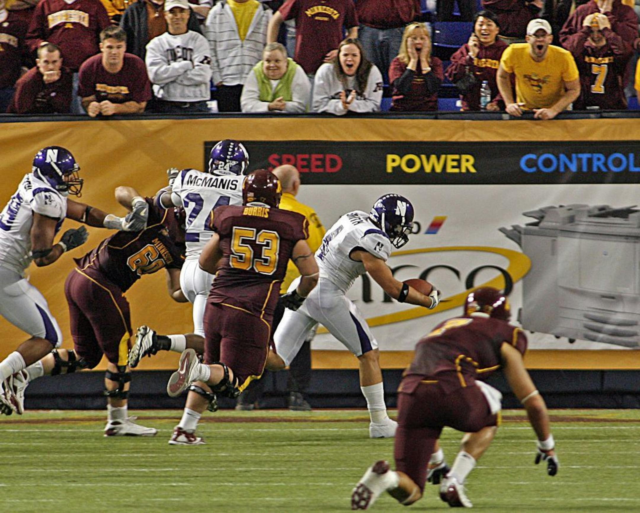 FILE - Nov. 1, 2008. Northwestern safety Brendan Smith crossed into the end zone with the winning touchdown late in the fourth quarter after intercepting a pass intended for Gophers receiver Eric Decker, bottom right.